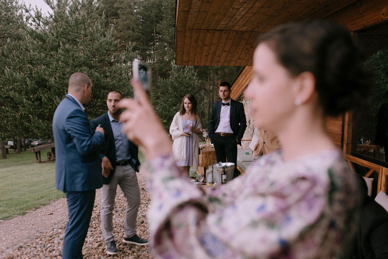 Rustic wooden venue decorated with string lights for outdoor celebration.