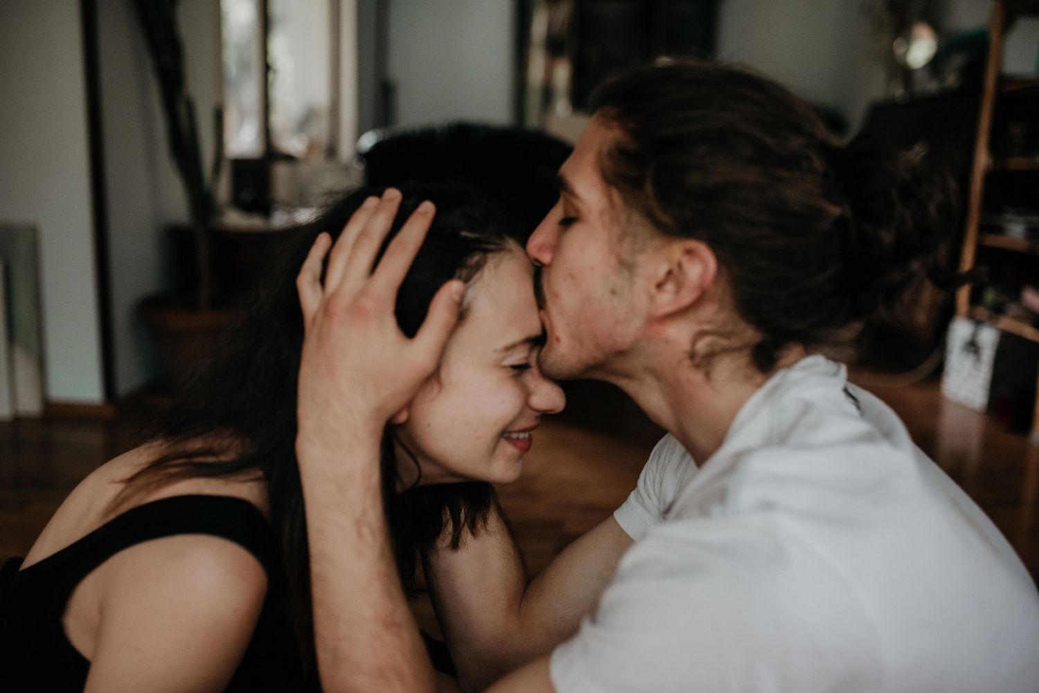 A romantic moment captured in black and white as a couple shares an intimate kiss.