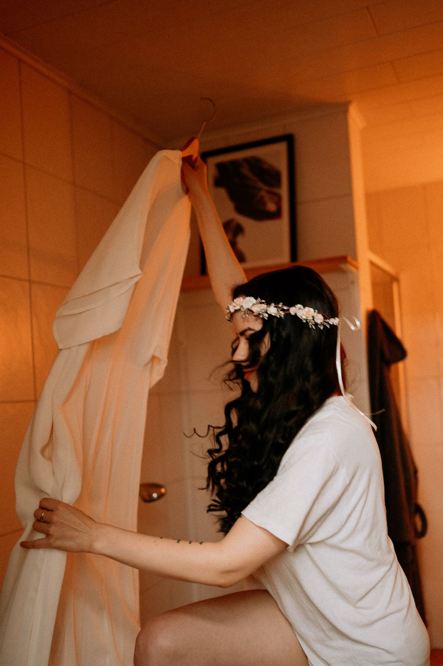 Multiple frames showing movement in white fabric against an orange-lit interior.