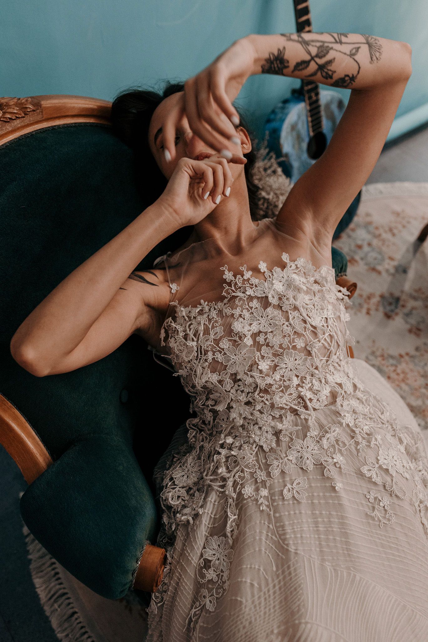 Artistic shot of lace wedding dress details with floral appliques and delicate beadwork.