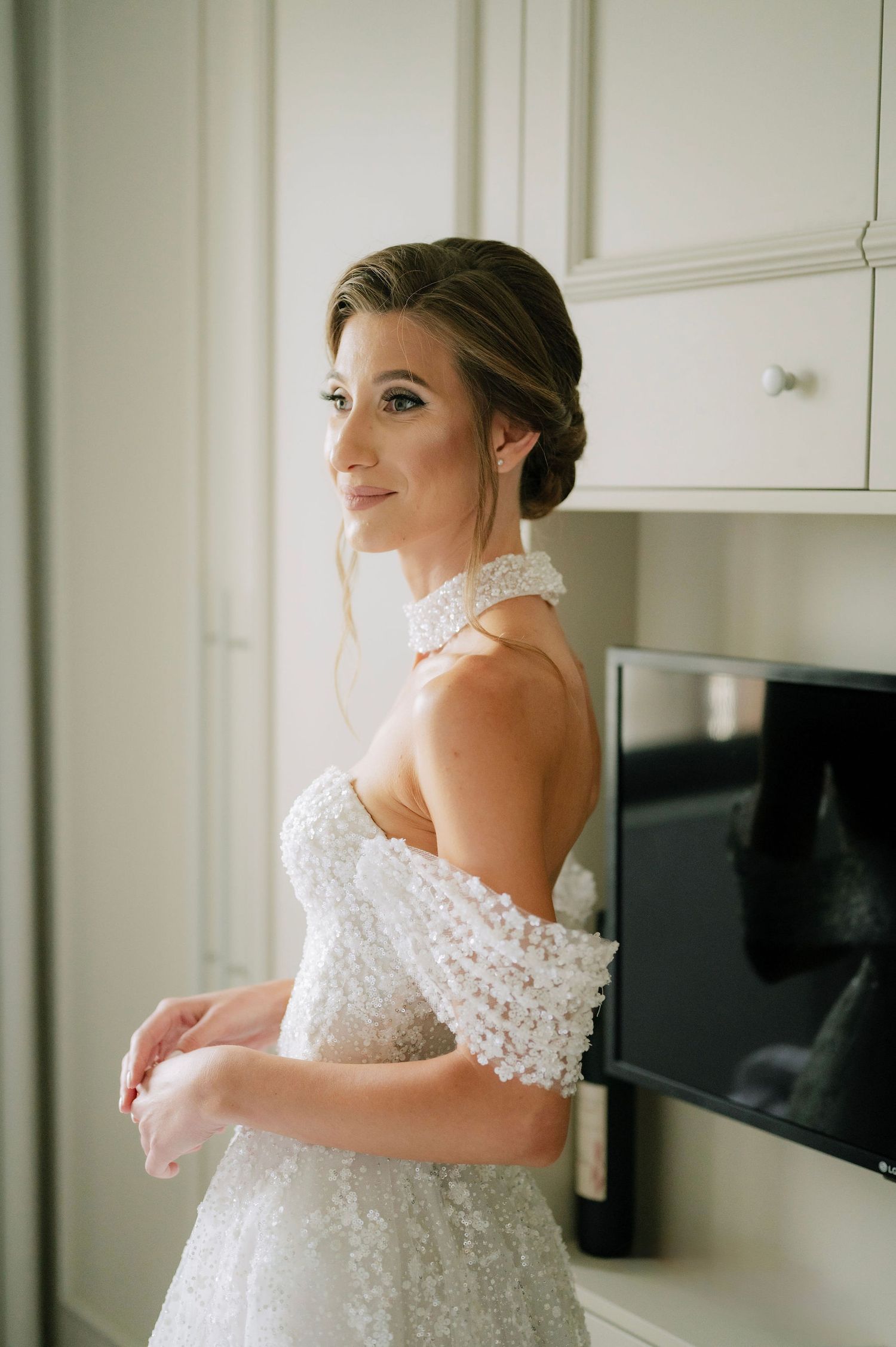 Close-up shot of delicate off-shoulder lace details on a wedding dress.