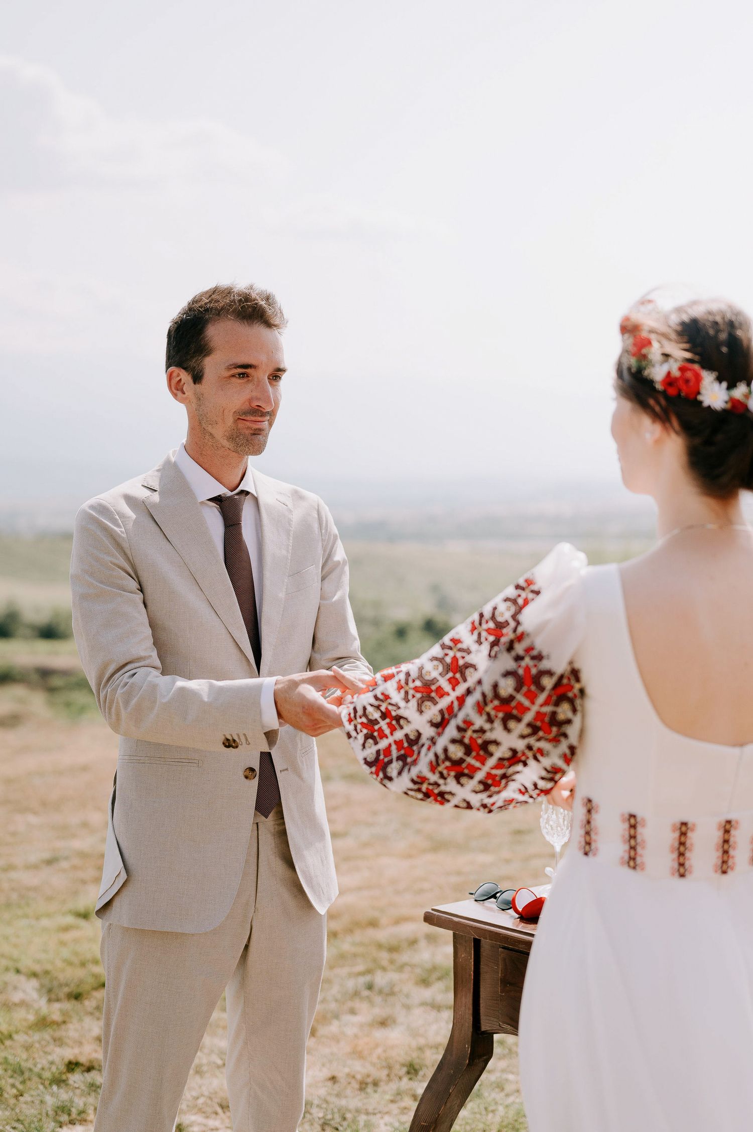A couple sharing a moment during their outdoor desert wedding ceremony.