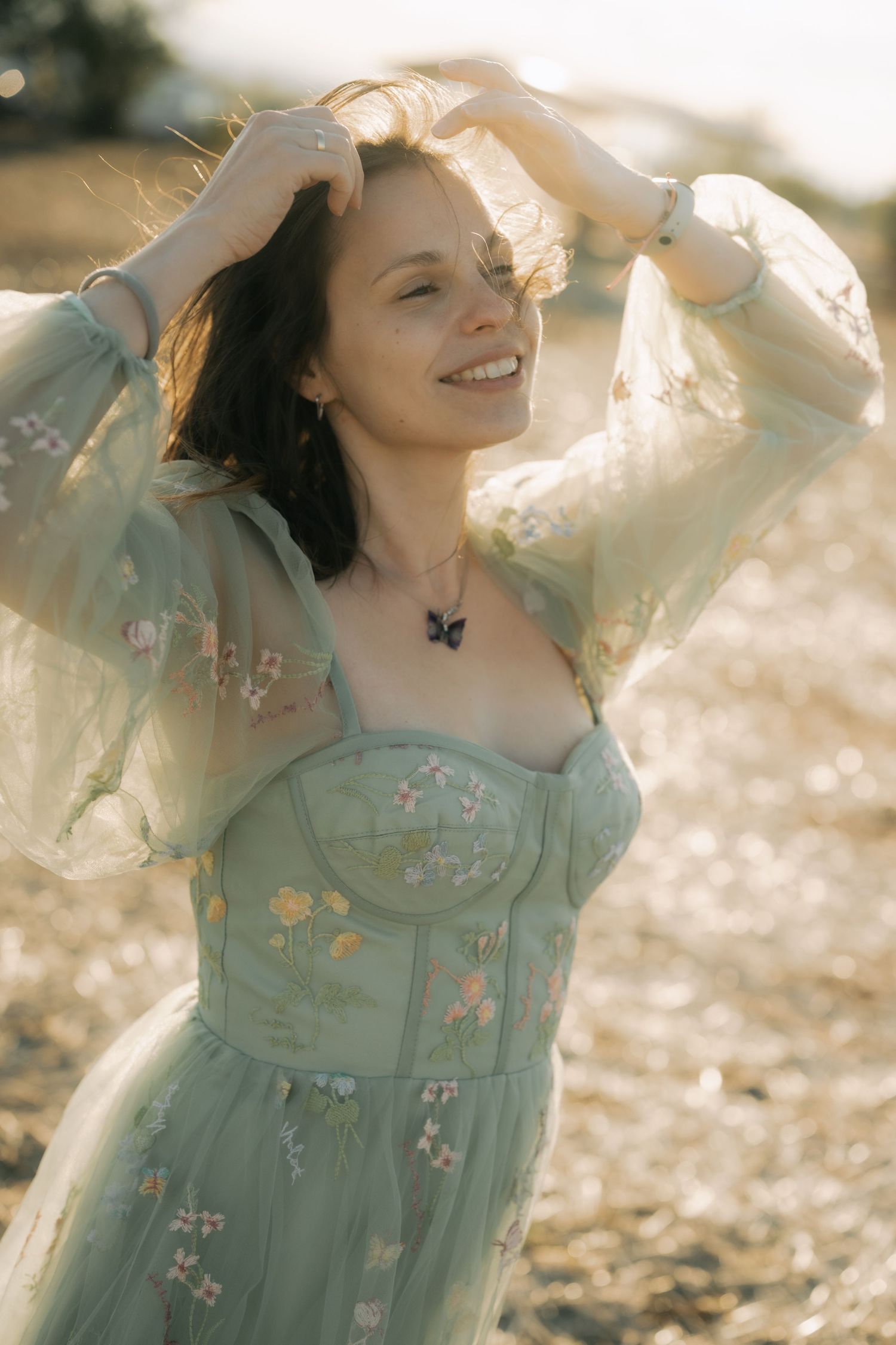 Ethereal portrait series in mint green dress with floral embroidery captured in dreamy golden sunlight.