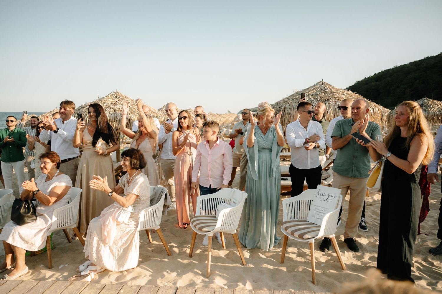 A series of wedding party photos showing people dancing and celebrating at a reception in a bright venue.