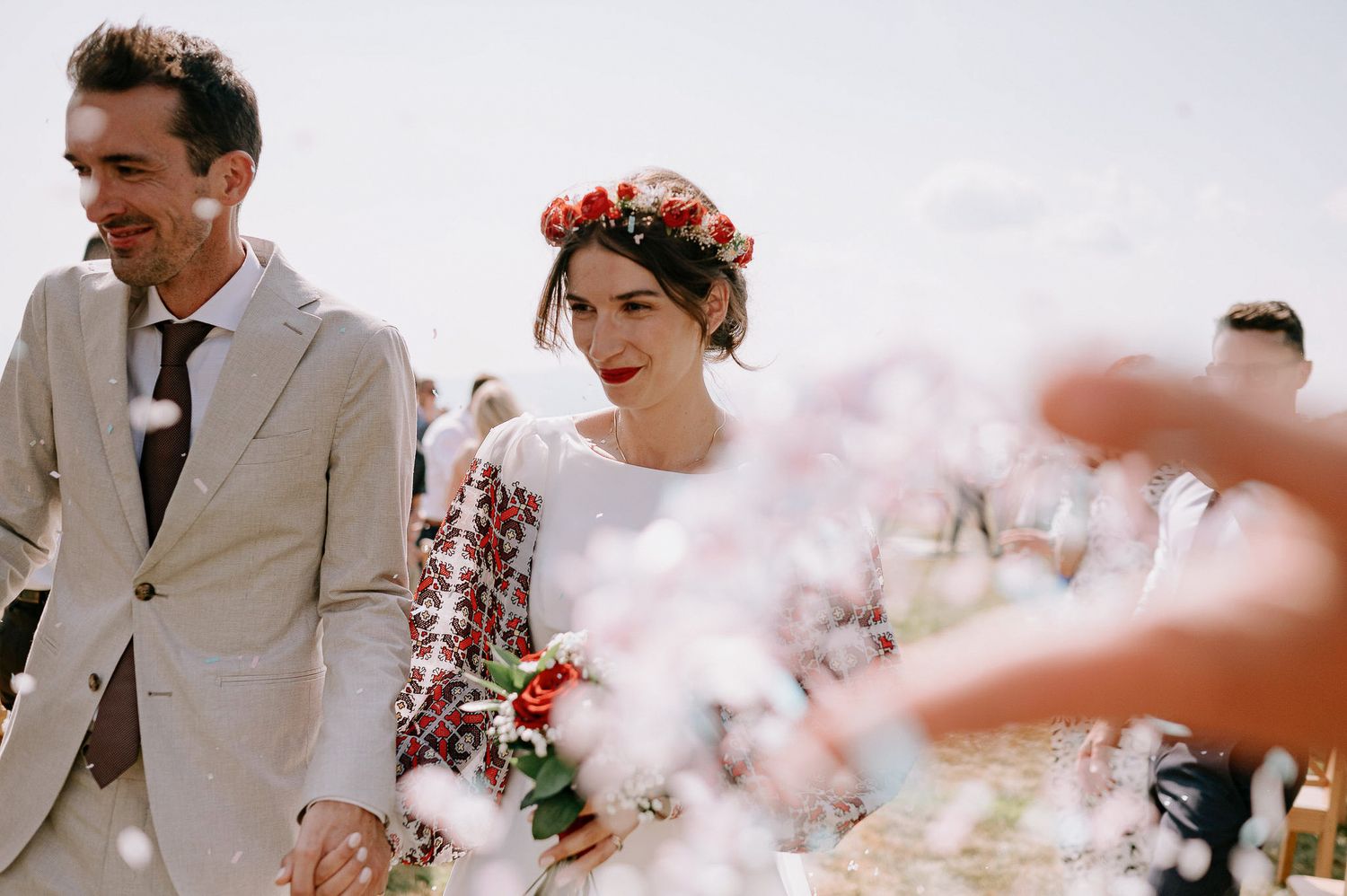 Newlyweds walk through a dreamy haze during their outdoor wedding ceremony.