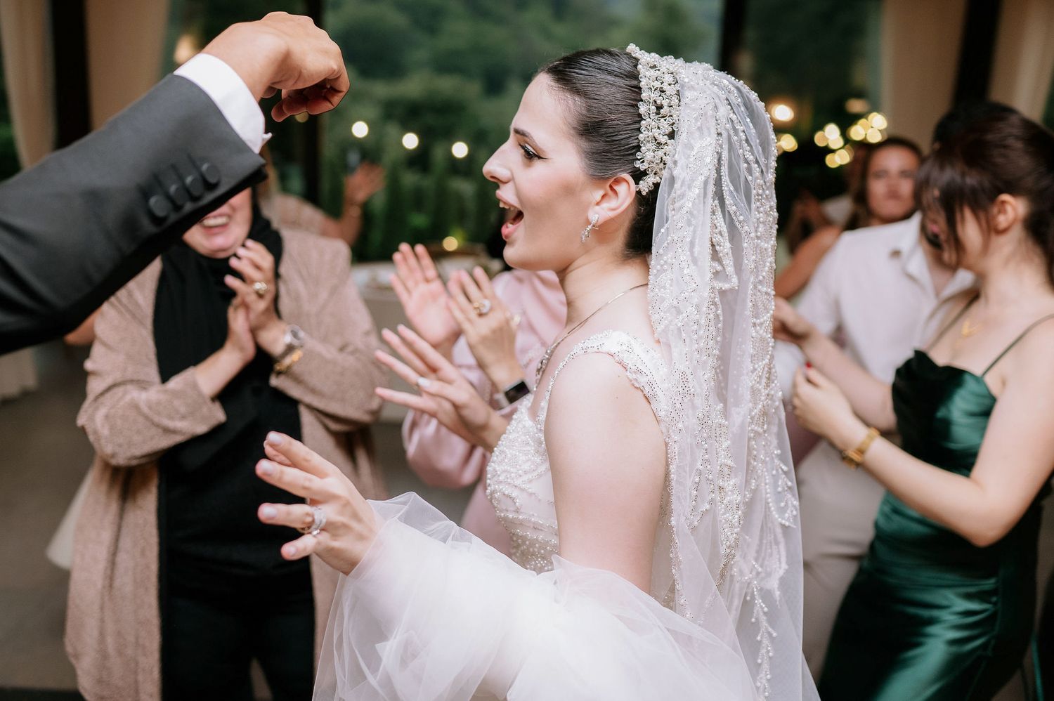 Guests dancing and celebrating at an elegant indoor wedding reception.