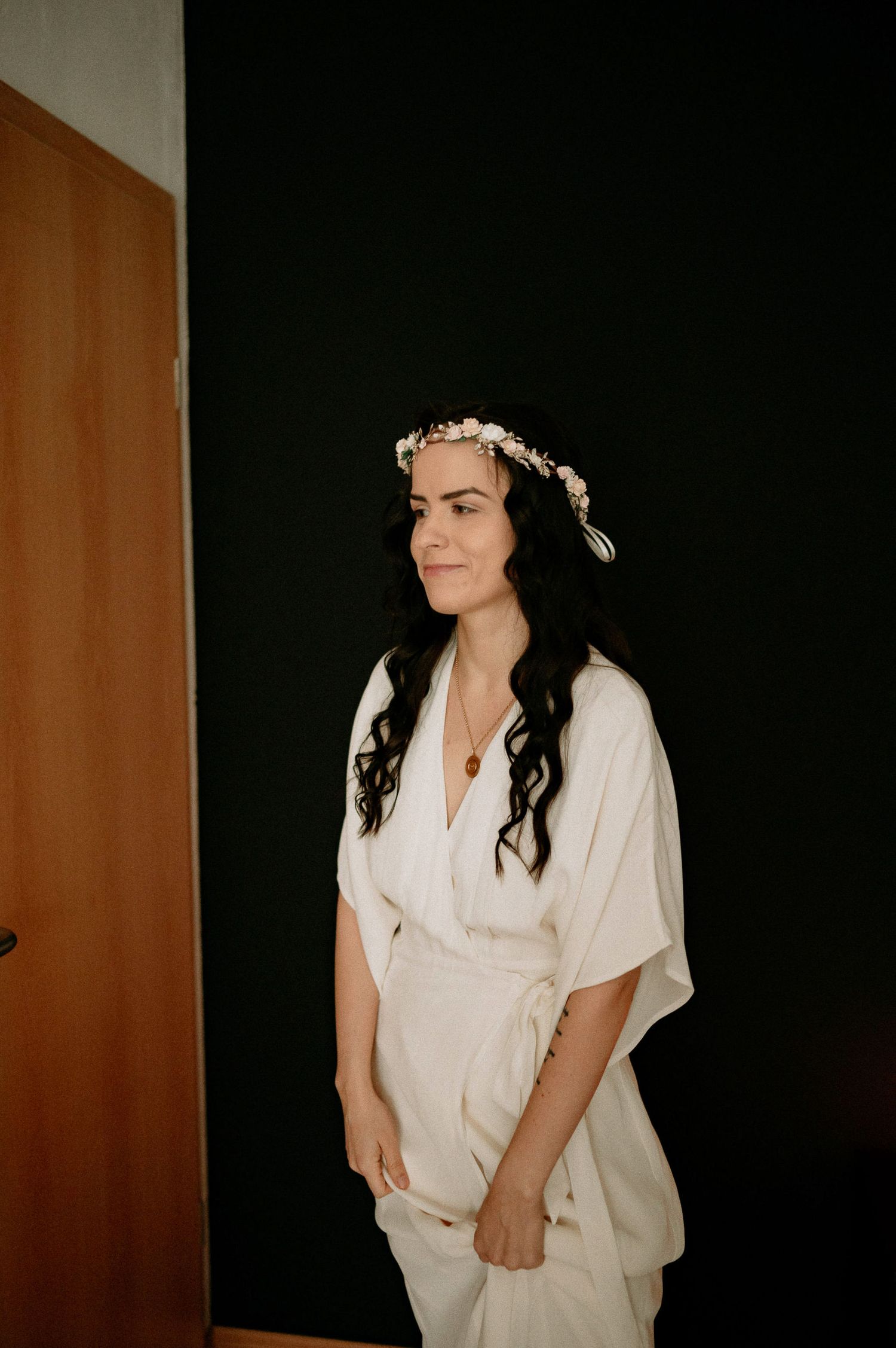 Portrait series showing someone wearing a white dress and floral headpiece against a dark background.