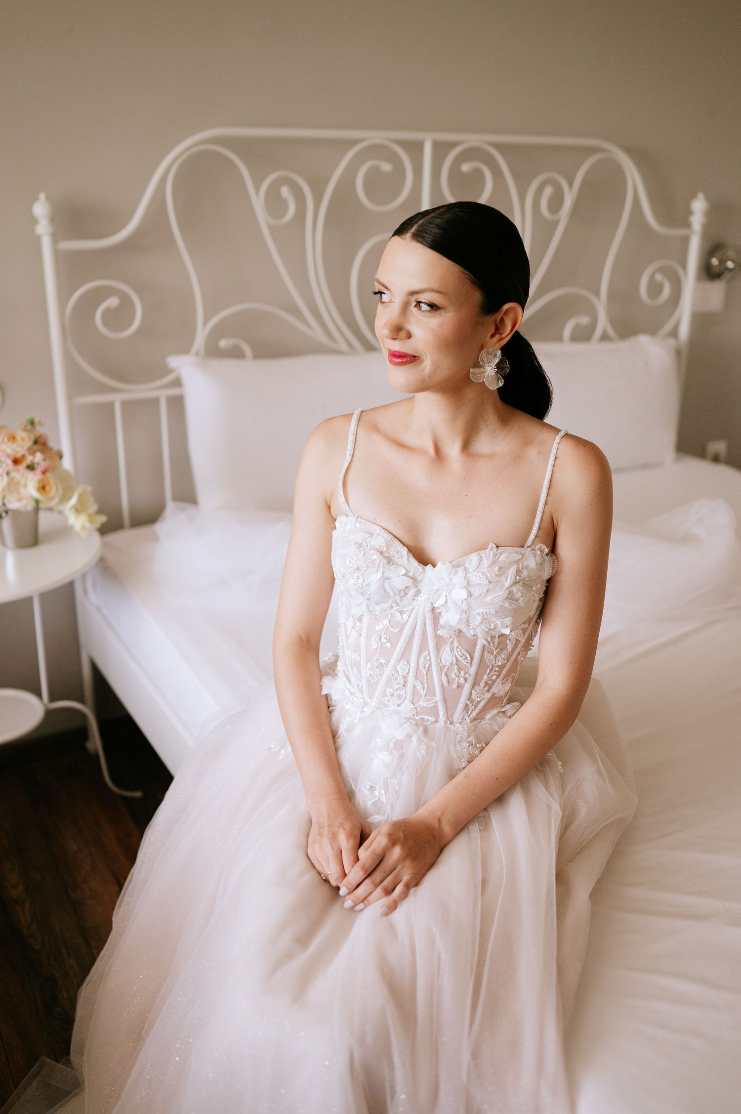 Classic wedding dress with sweetheart neckline and lace details captured in intimate bedroom setting.