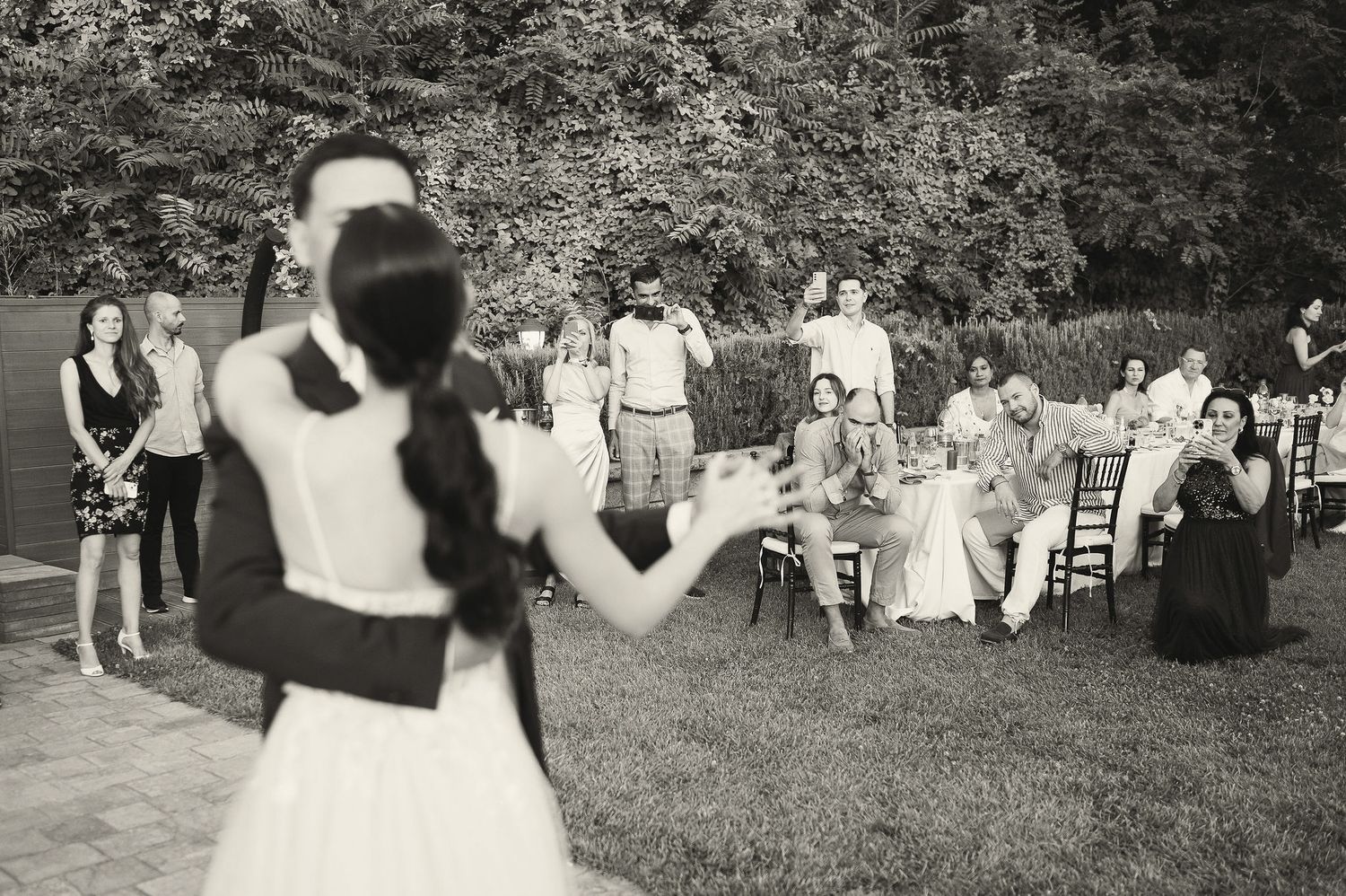 Black and white wedding ceremony photos showing dancing and celebration.