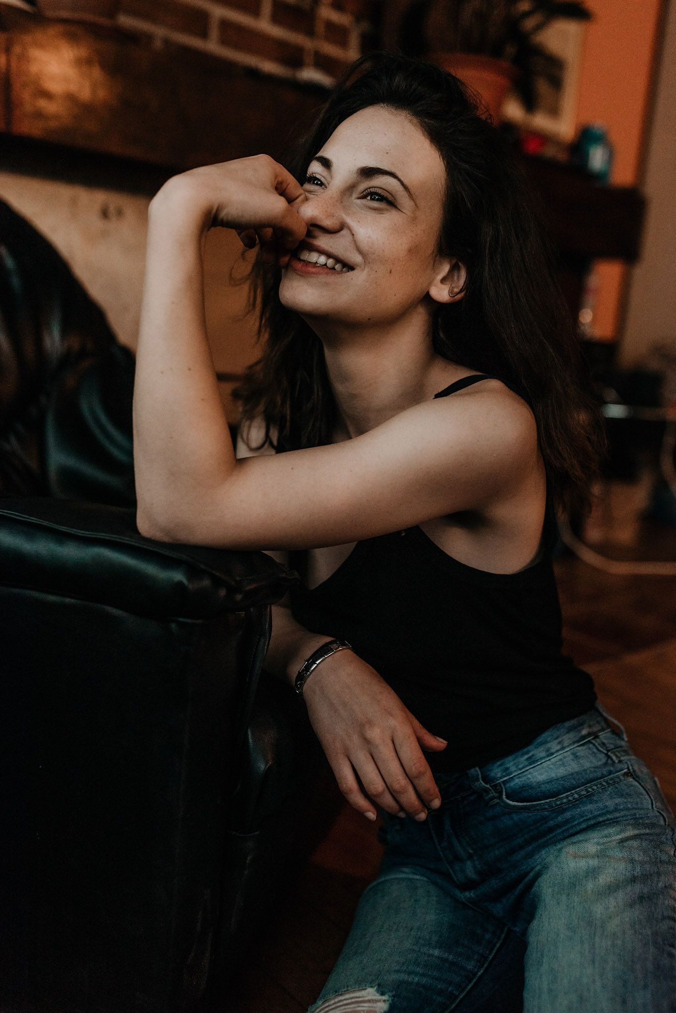A playful series of candid moments showing a couple embracing in warm indoor lighting.