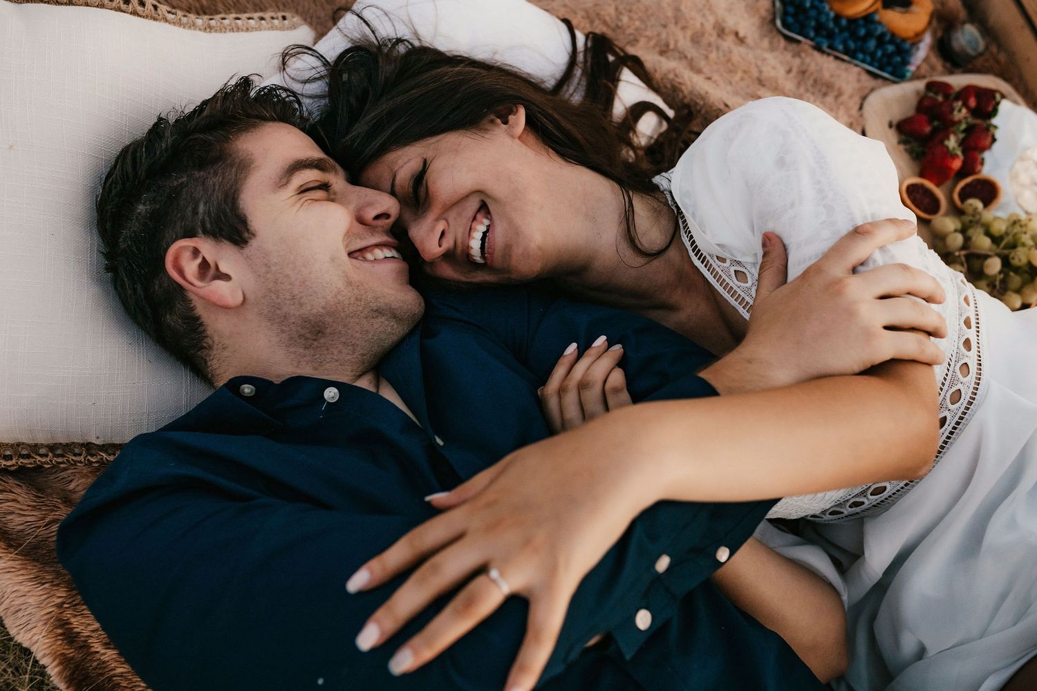 Couple sharing tender moments while lying down together.