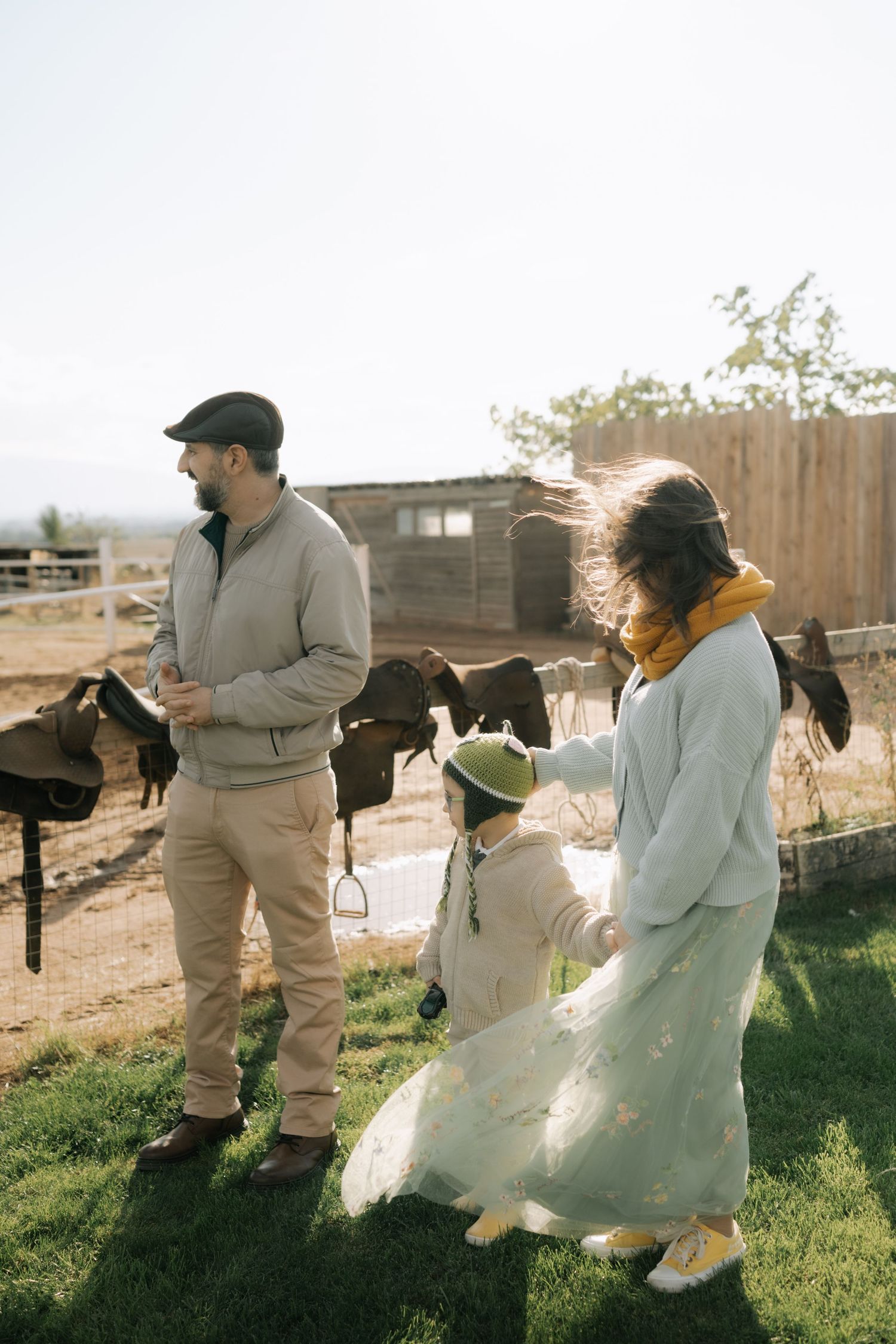 A sequence of playful chase photos showing a couple running through a sunlit field in casual and wedding attire.