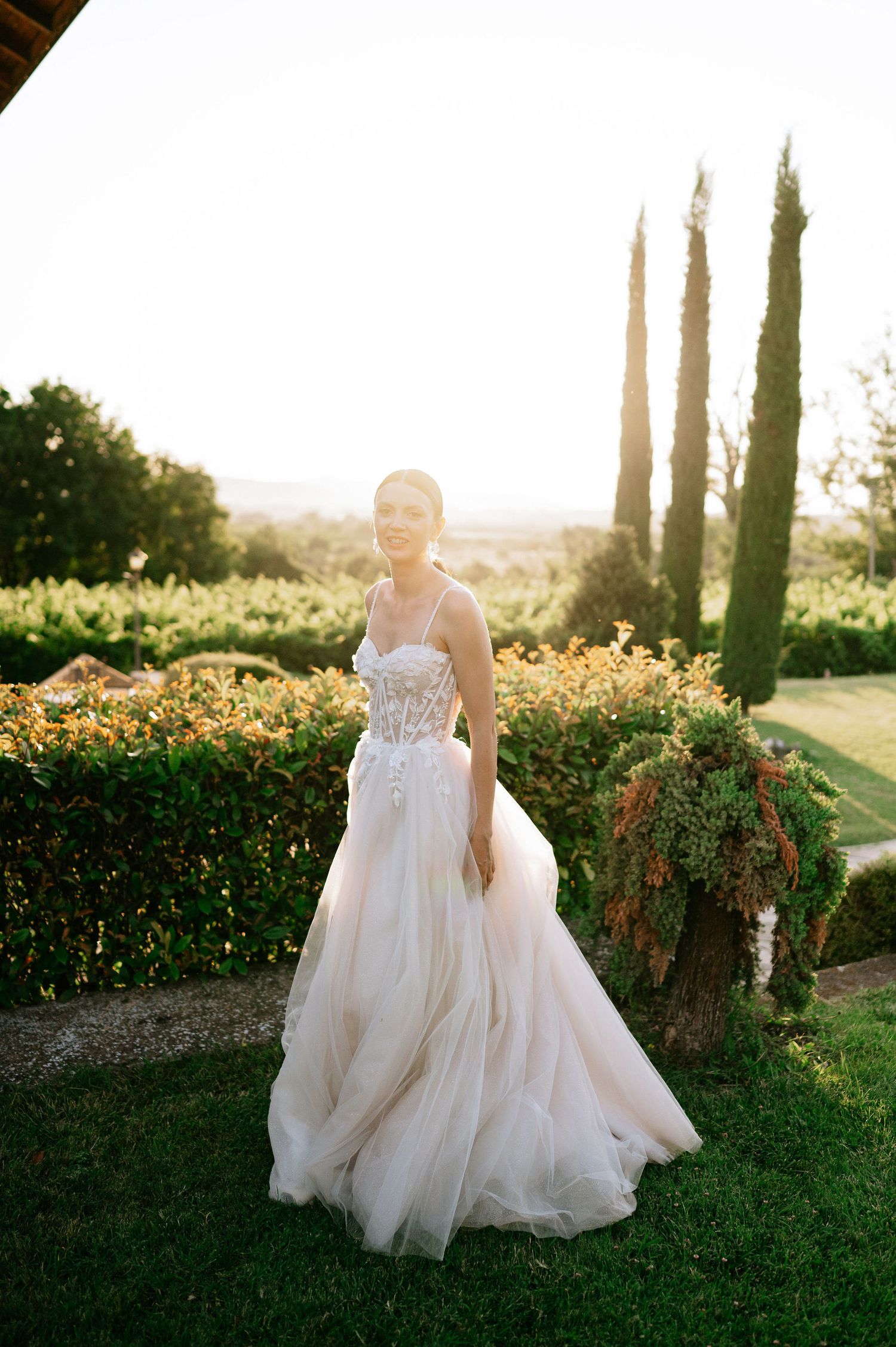 Romantic bridal portrait featuring a structured bodice gown in a Mediterranean garden setting.