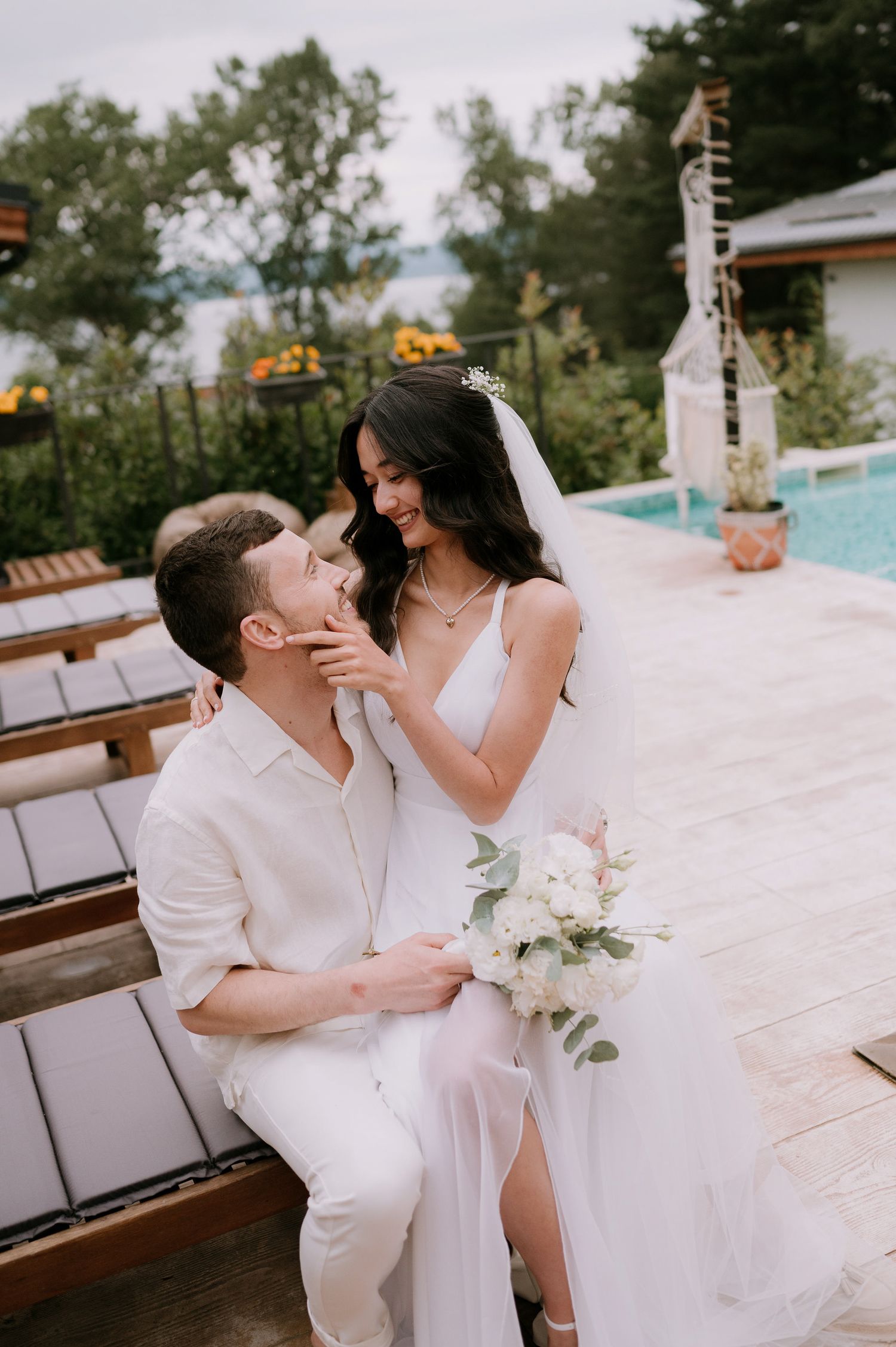 Romantic poolside wedding photography sequence with couple in white sharing intimate moments.