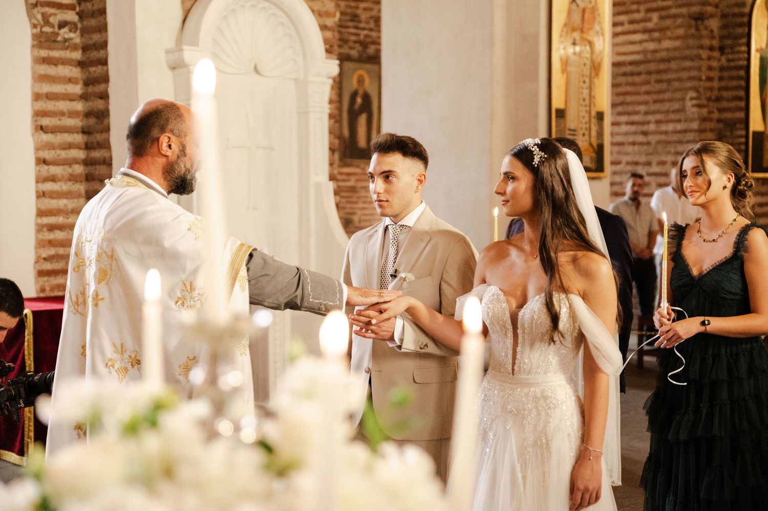 Wedding reception scene with elegant table settings and guests in formal attire.
