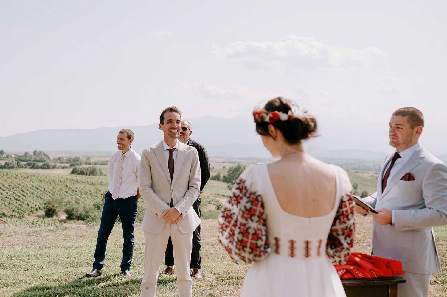 Wedding celebration candid moments captured on scenic hillside location.