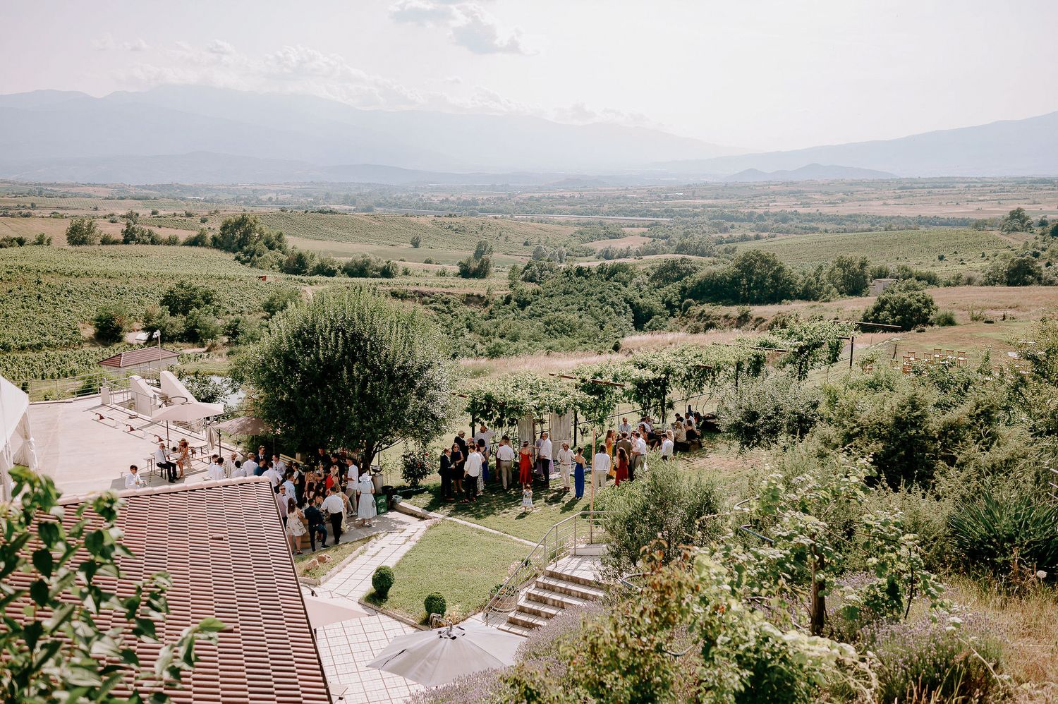Panoramic view of a scenic outdoor wedding venue with rolling hills in the background.