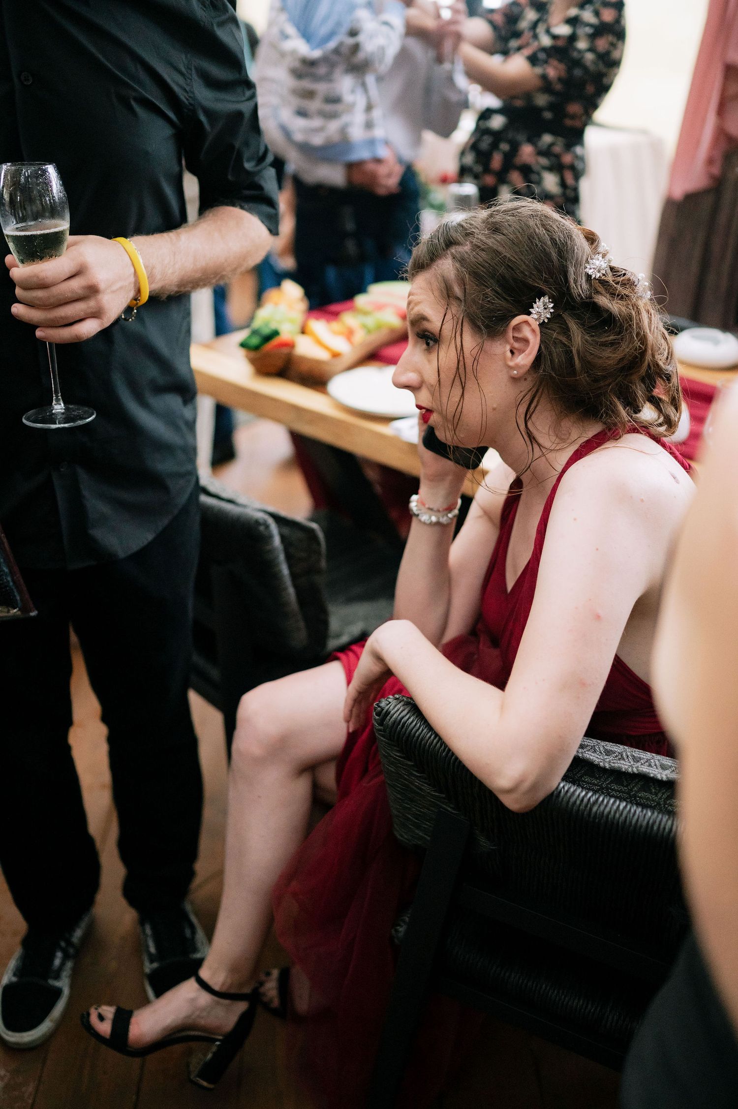 Guests seated at tables during a social event with wine glasses.
