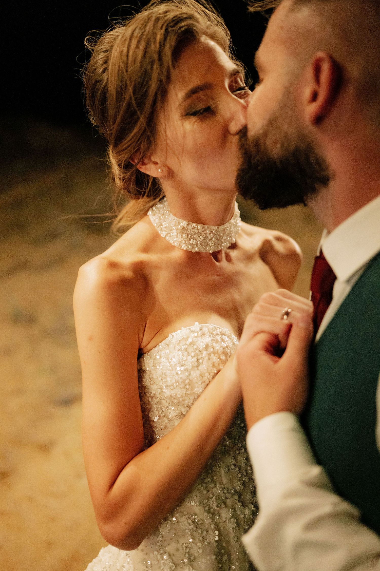 Romantic wedding couple sharing an intimate moment during golden hour.