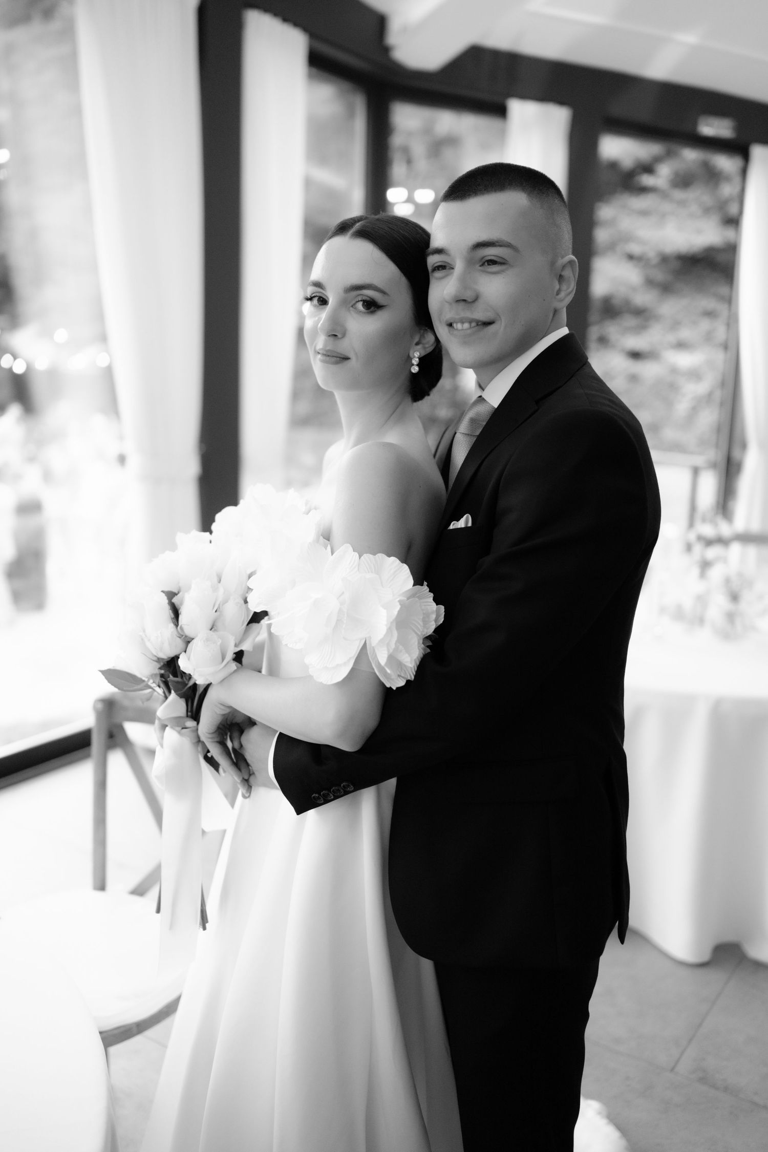 A black and white wedding photo sequence showing a couple dancing together in formal attire.