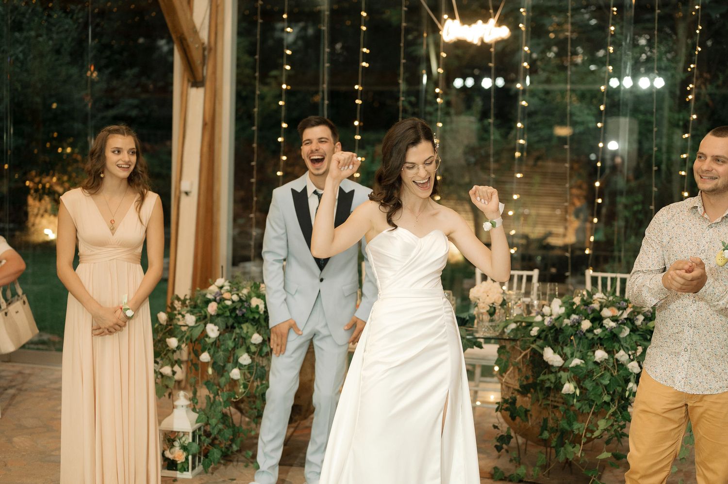 A series of wedding reception photos showing dancing and celebration under twinkling string lights in an elegant venue.