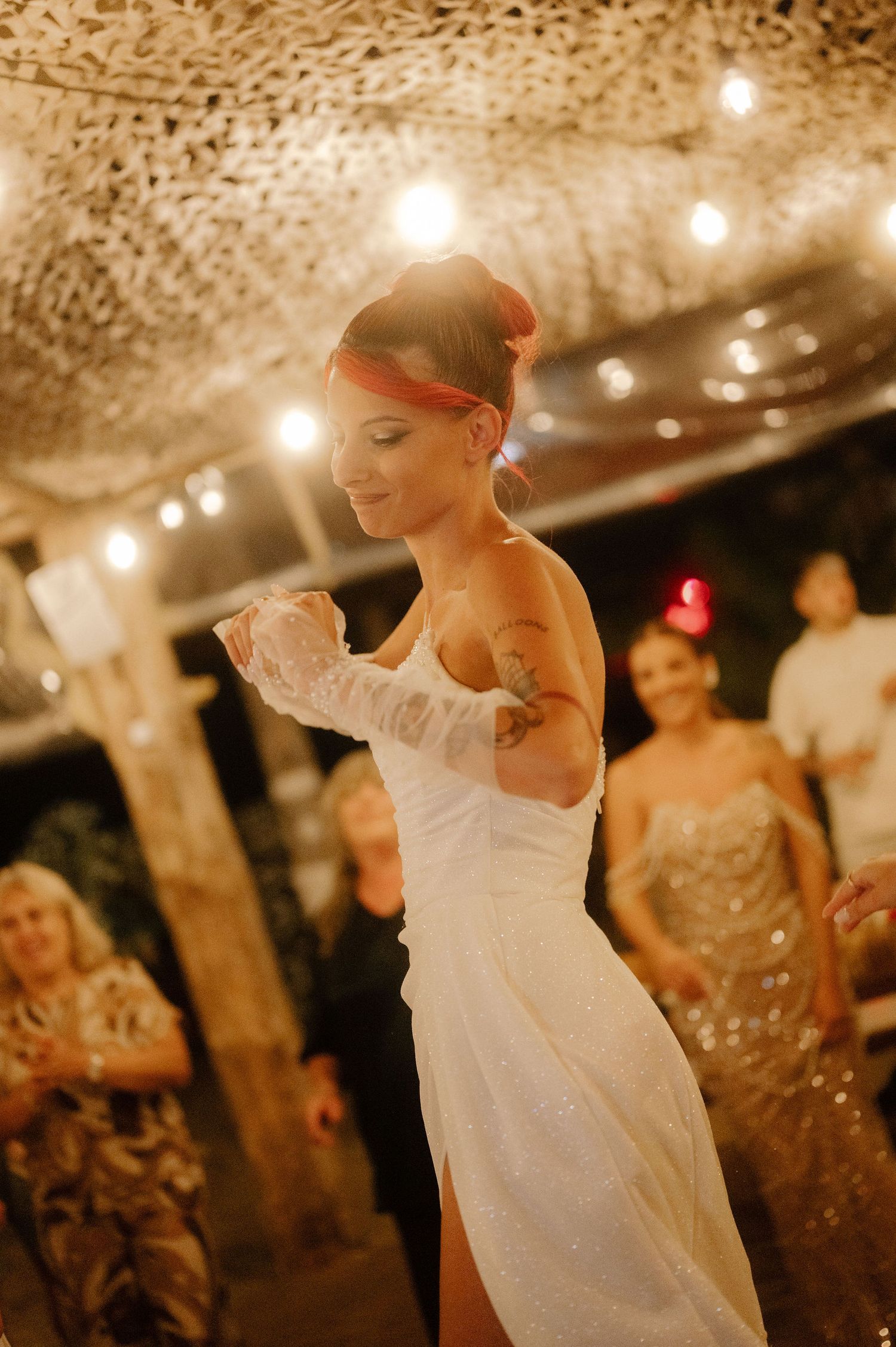 A sequence of romantic dance moves captured at a wedding reception with string lights creating a warm ambiance.
