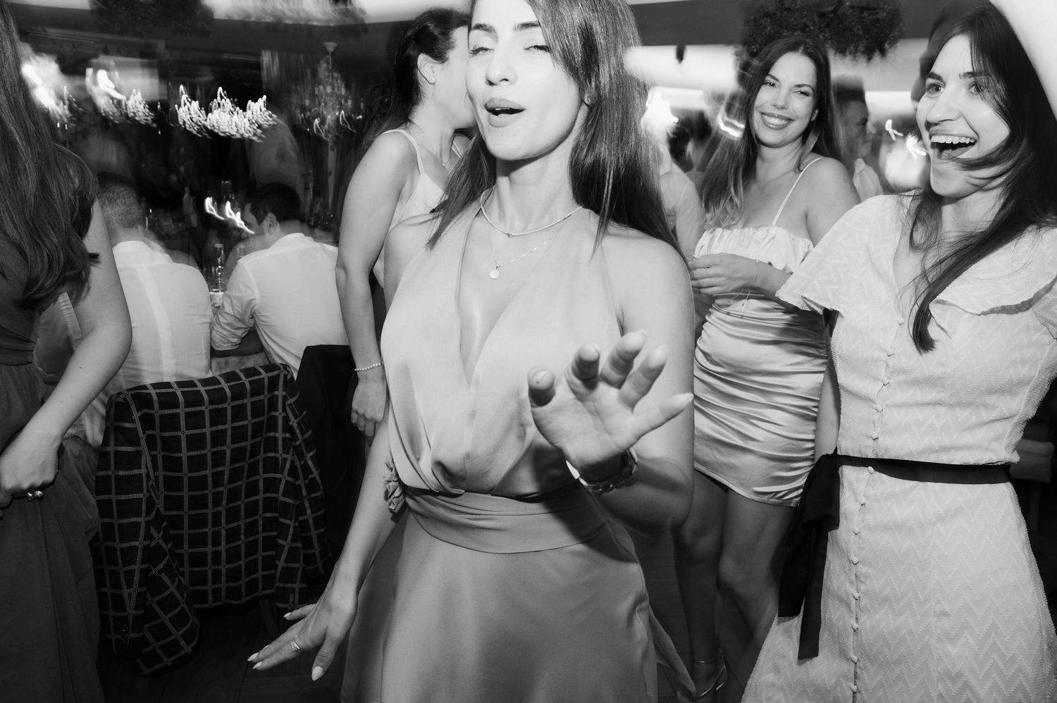 A group of people dancing and celebrating together at a lively party or social gathering.