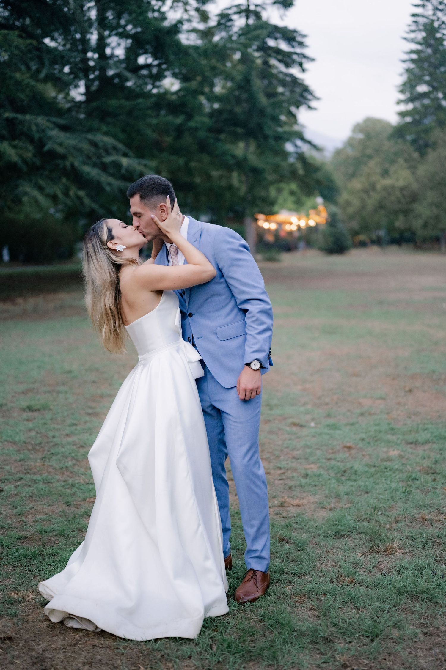 A romantic outdoor wedding photoshoot sequence showing a couple dancing and dipping in a grassy field at sunset.