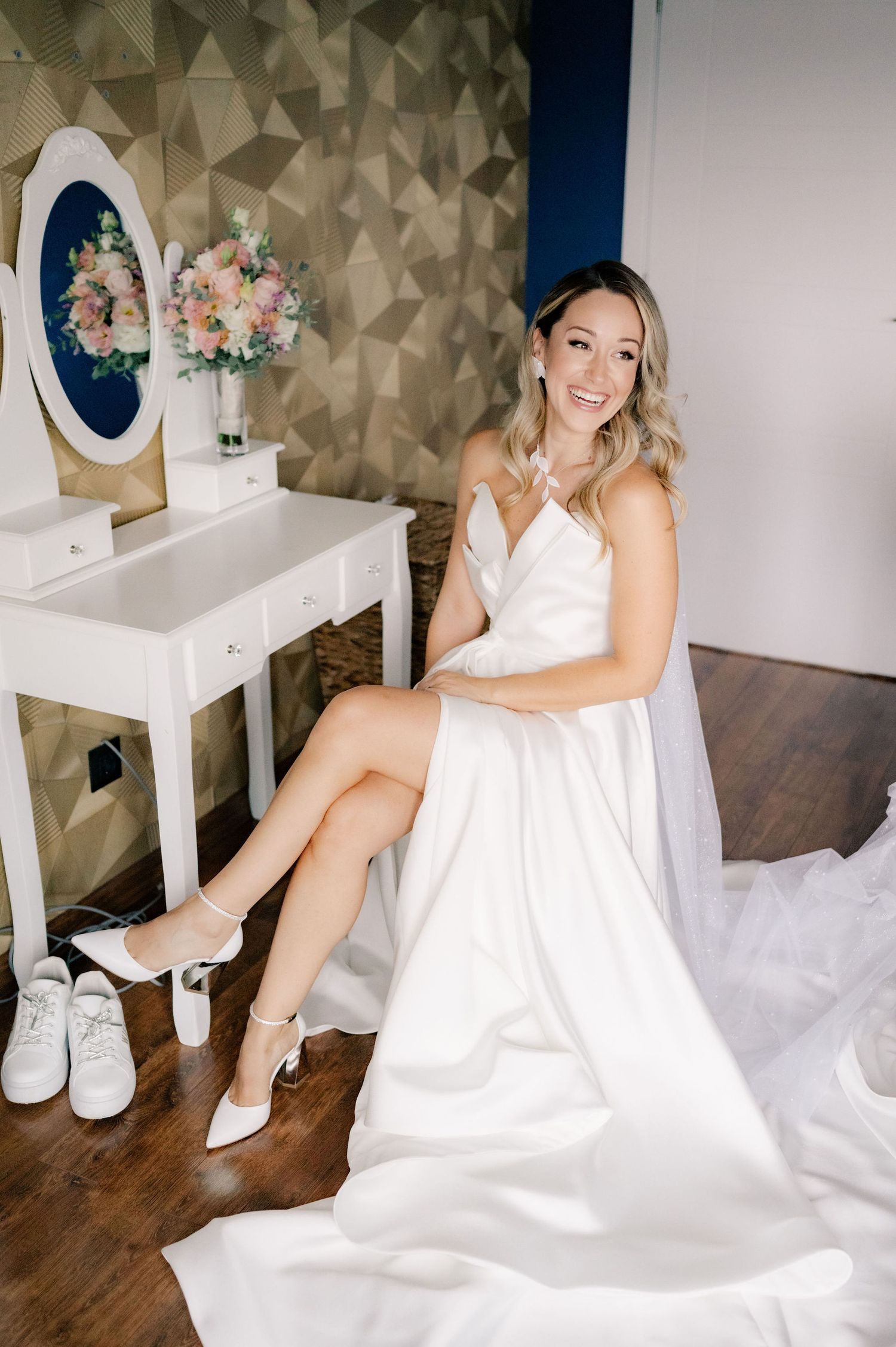 Artistic sequence of a bride in a white gown sitting on hardwood floors with geometric wallpaper behind her.