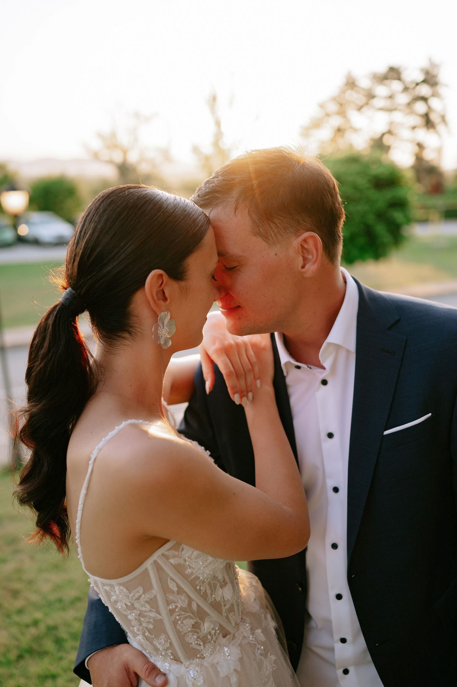 Romantic sunset wedding portraits capture intimate moments between the couple.