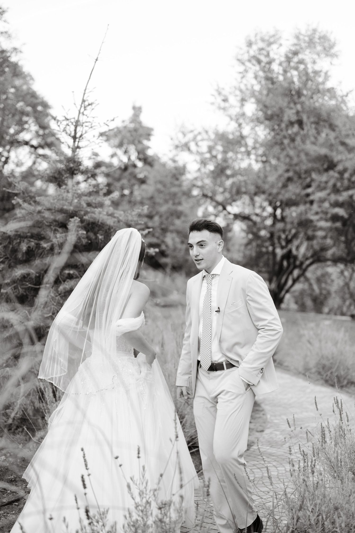 Romantic black and white wedding portraits taken in rustic outdoor setting.