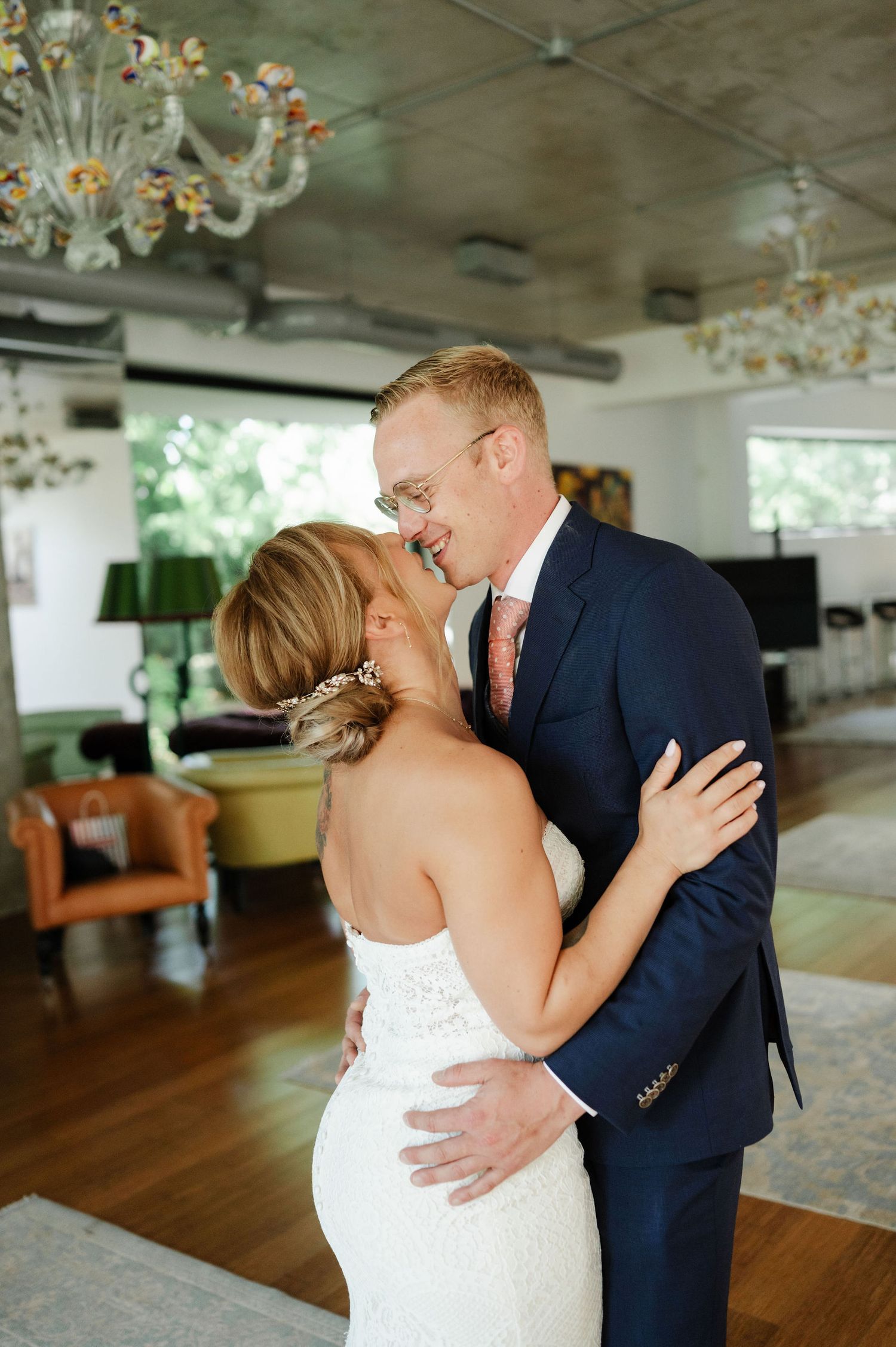 An intimate wedding dance moment captured in a light-filled reception venue.