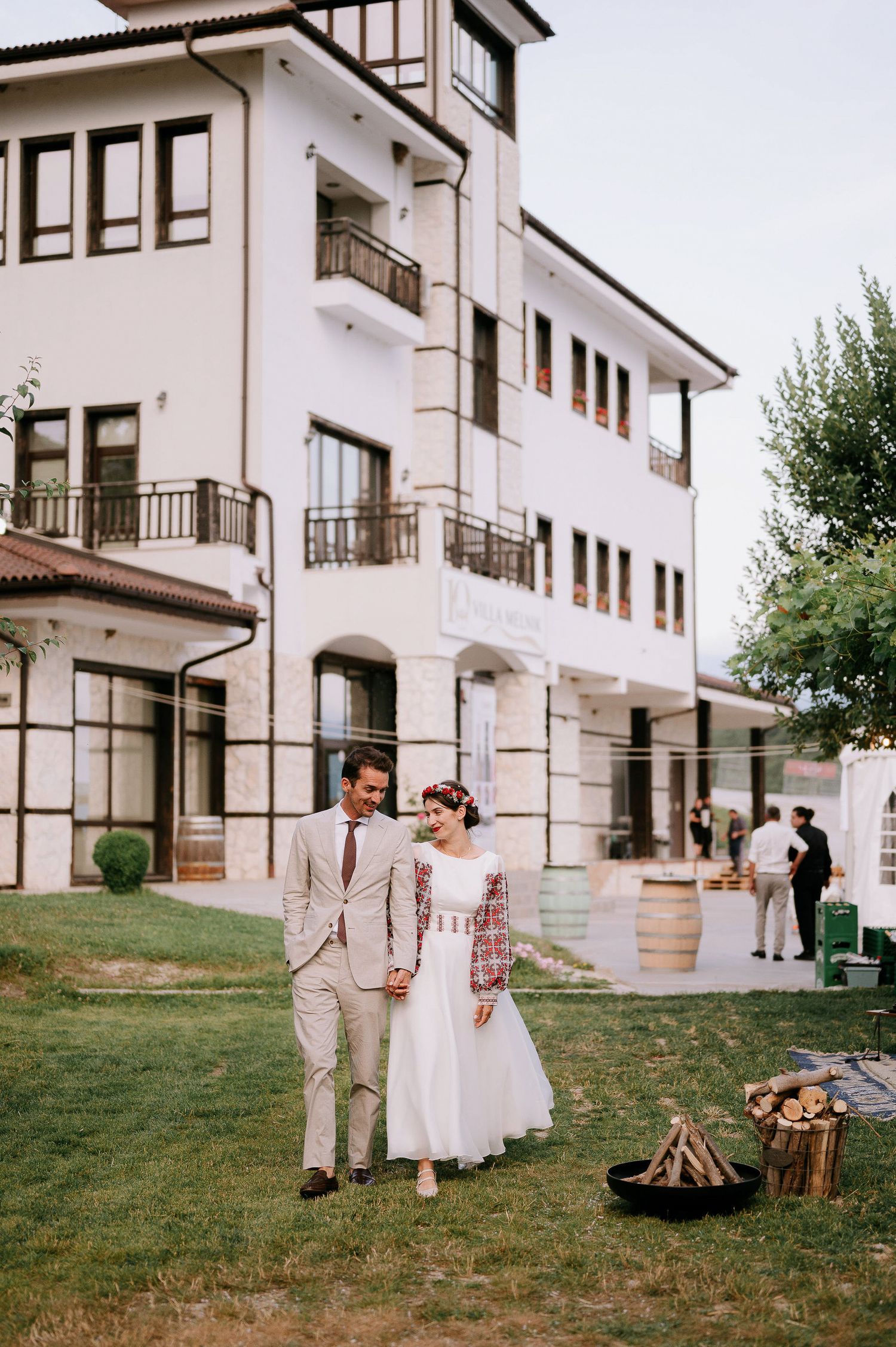 Wedding reception outside a beautiful white building with rustic outdoor decor.