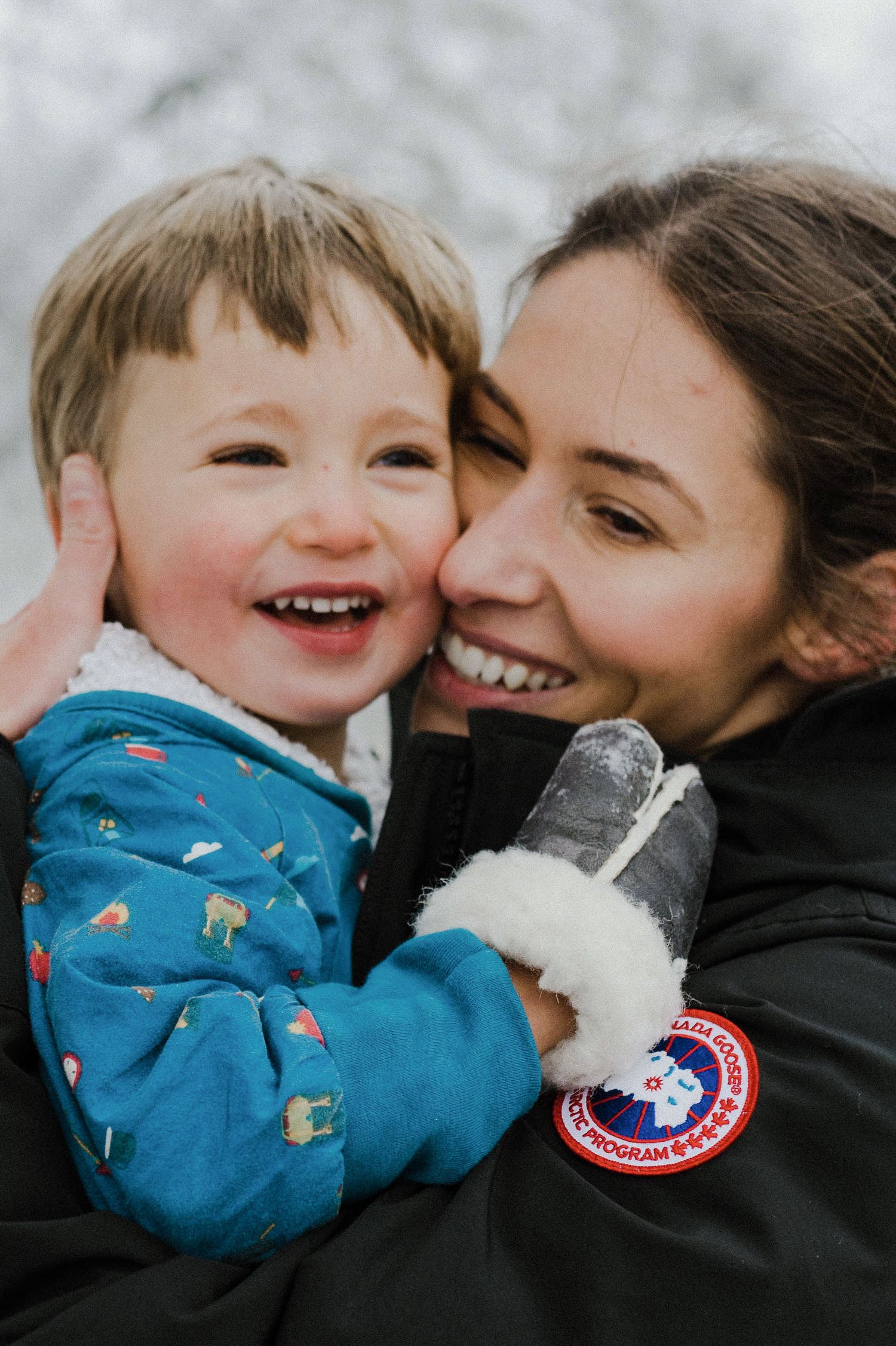A sequence of four candid photos showing joyful embraces while wearing a blue winter coat with a Canada Goose patch.