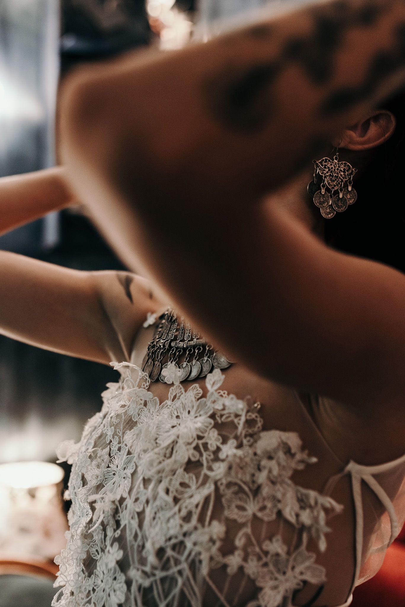 Detailed macro shots of delicate white lace wedding dress details.