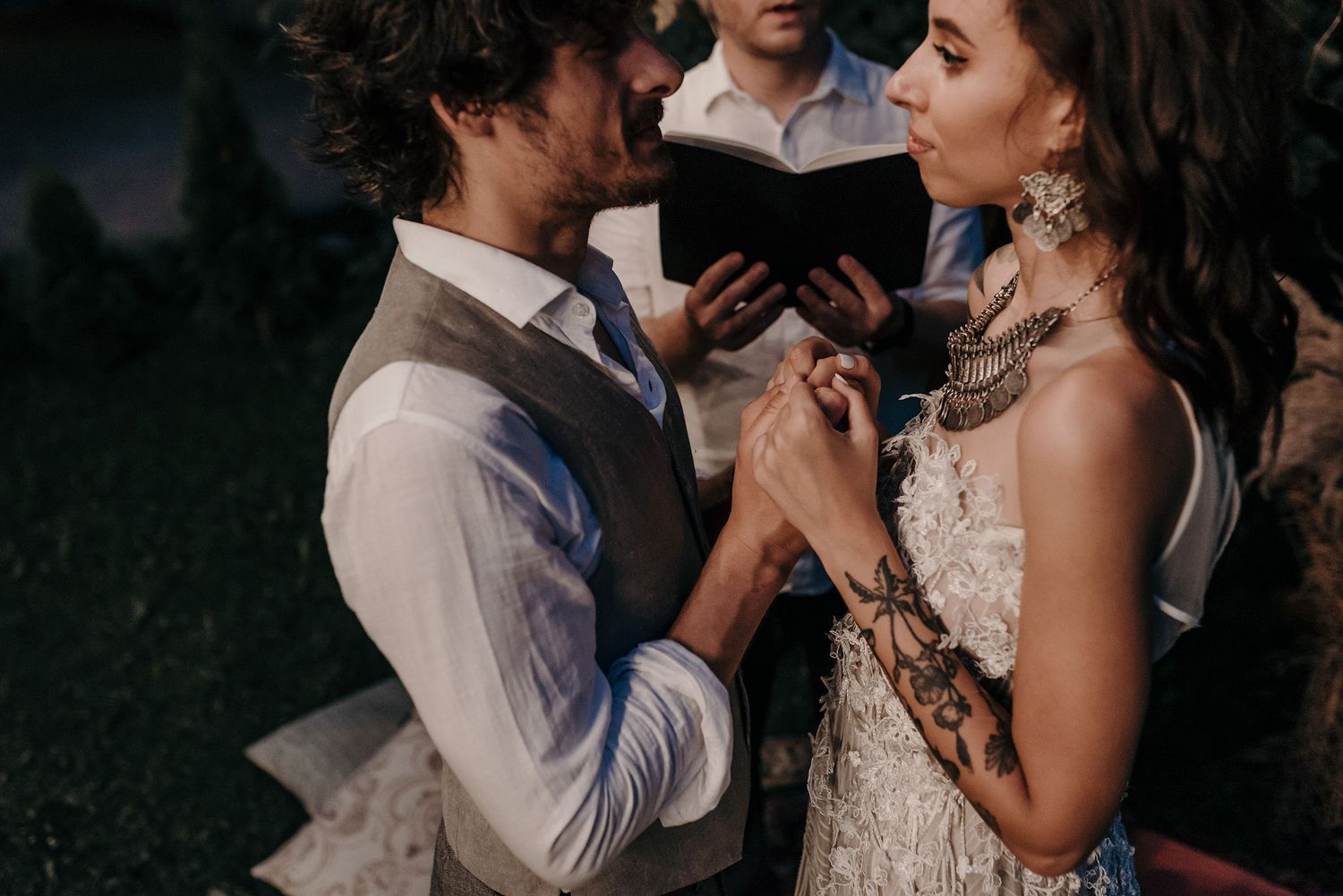 Couple sharing an intimate dance moment at dusk during their wedding celebration.