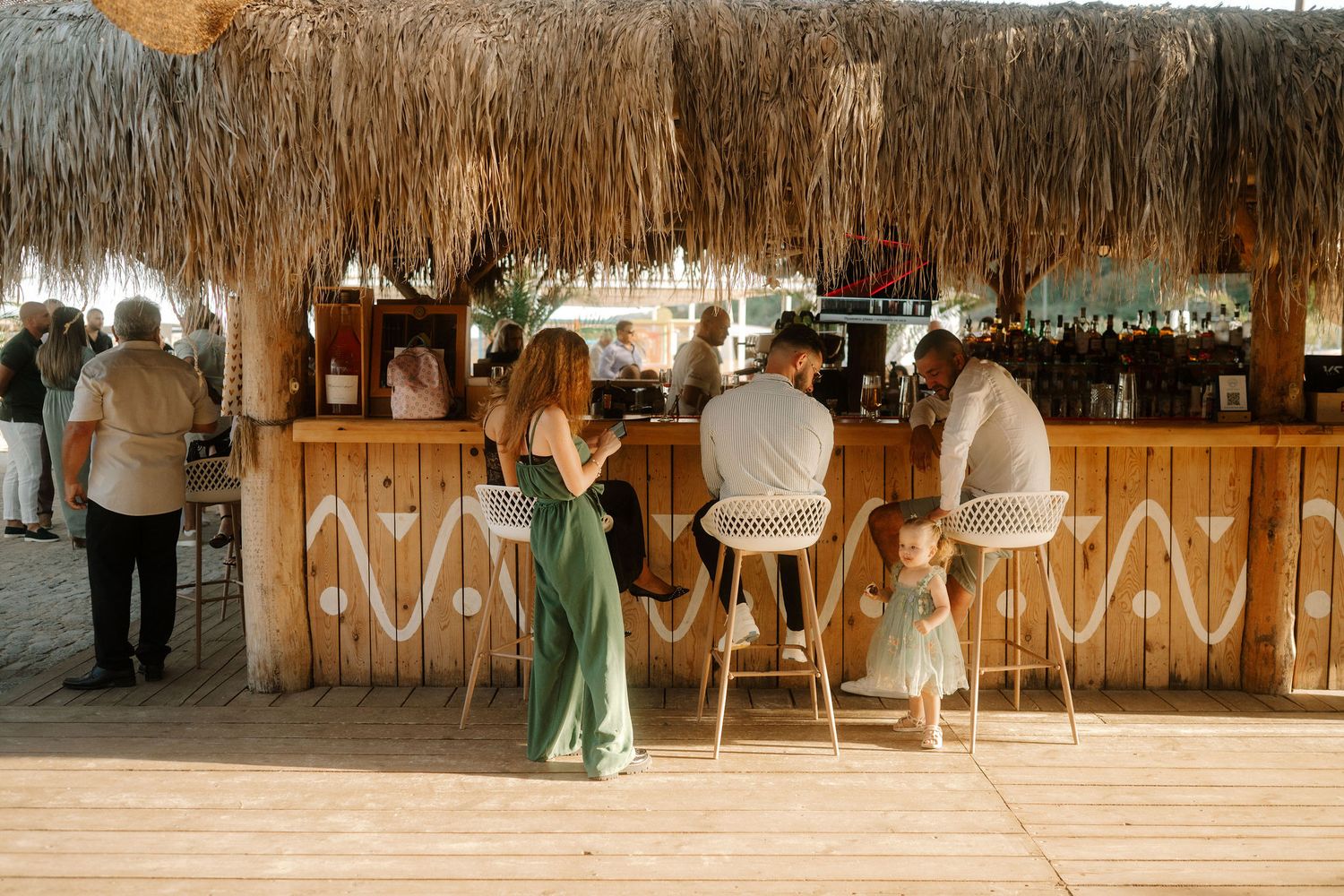 A panoramic view of a rustic wooden wedding reception venue with elegant table settings and string lights overhead.