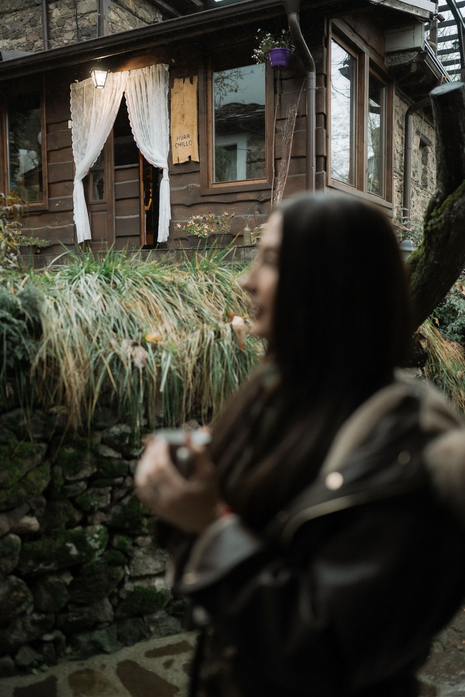 A series of dark, moody shots showing people in profile against a rustic wooden building backdrop.