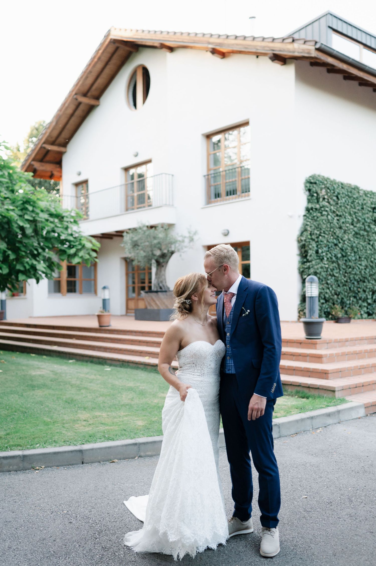 Bride and groom share intimate moments during their wedding photoshoot at a villa.
