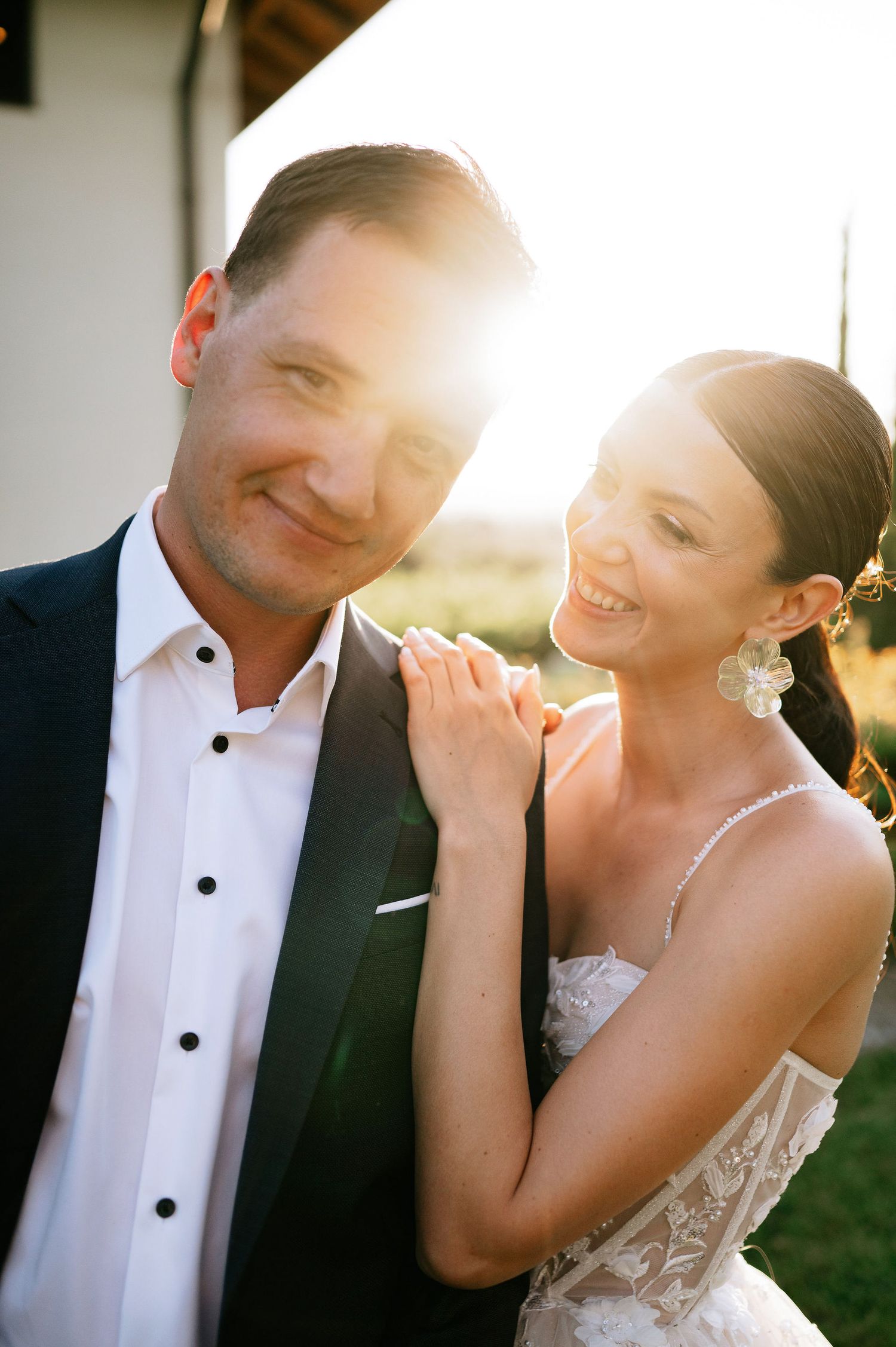 Wedding couple shares tender moments in warm evening light.