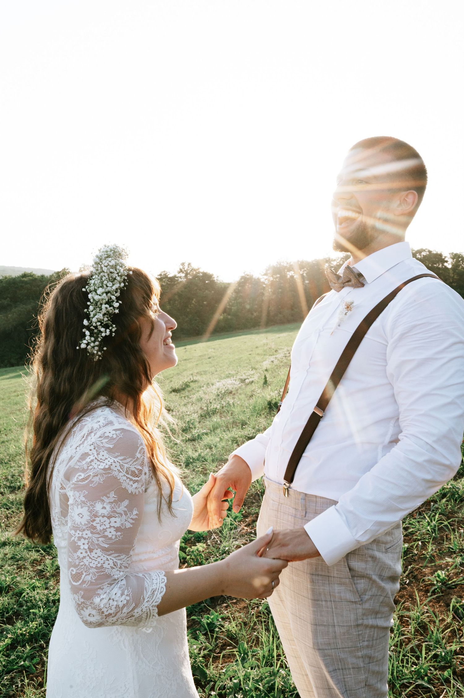 A romantic dance sequence between newlyweds in a sunlit field with delicate lace details.