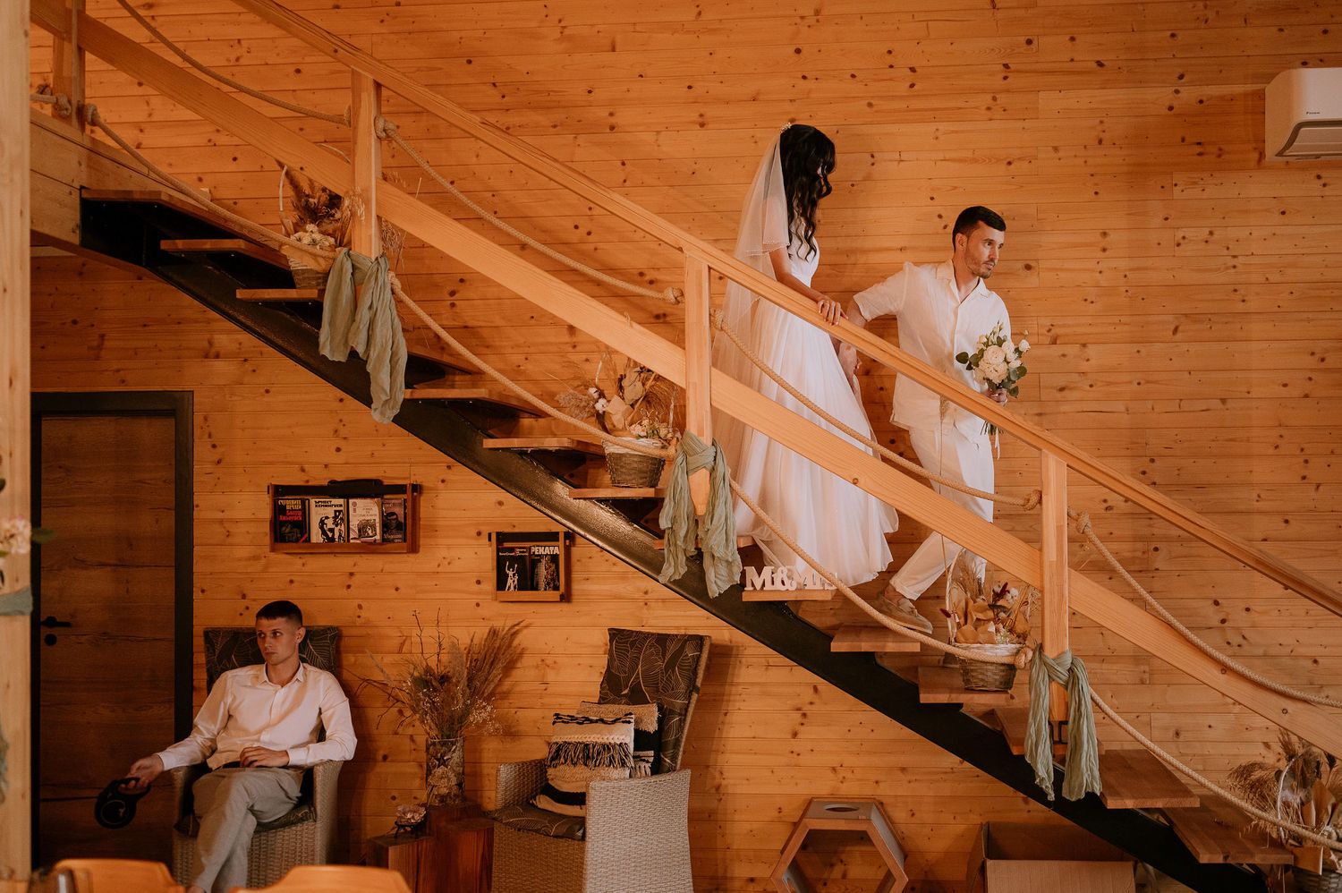Wedding photography session on wooden stairs in a cozy cabin setting.