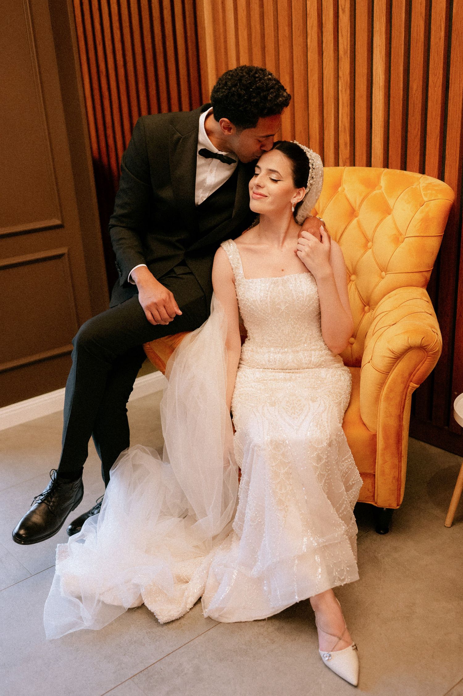 Wedding photography sequence showing intimate moments on a yellow velvet chair indoors.