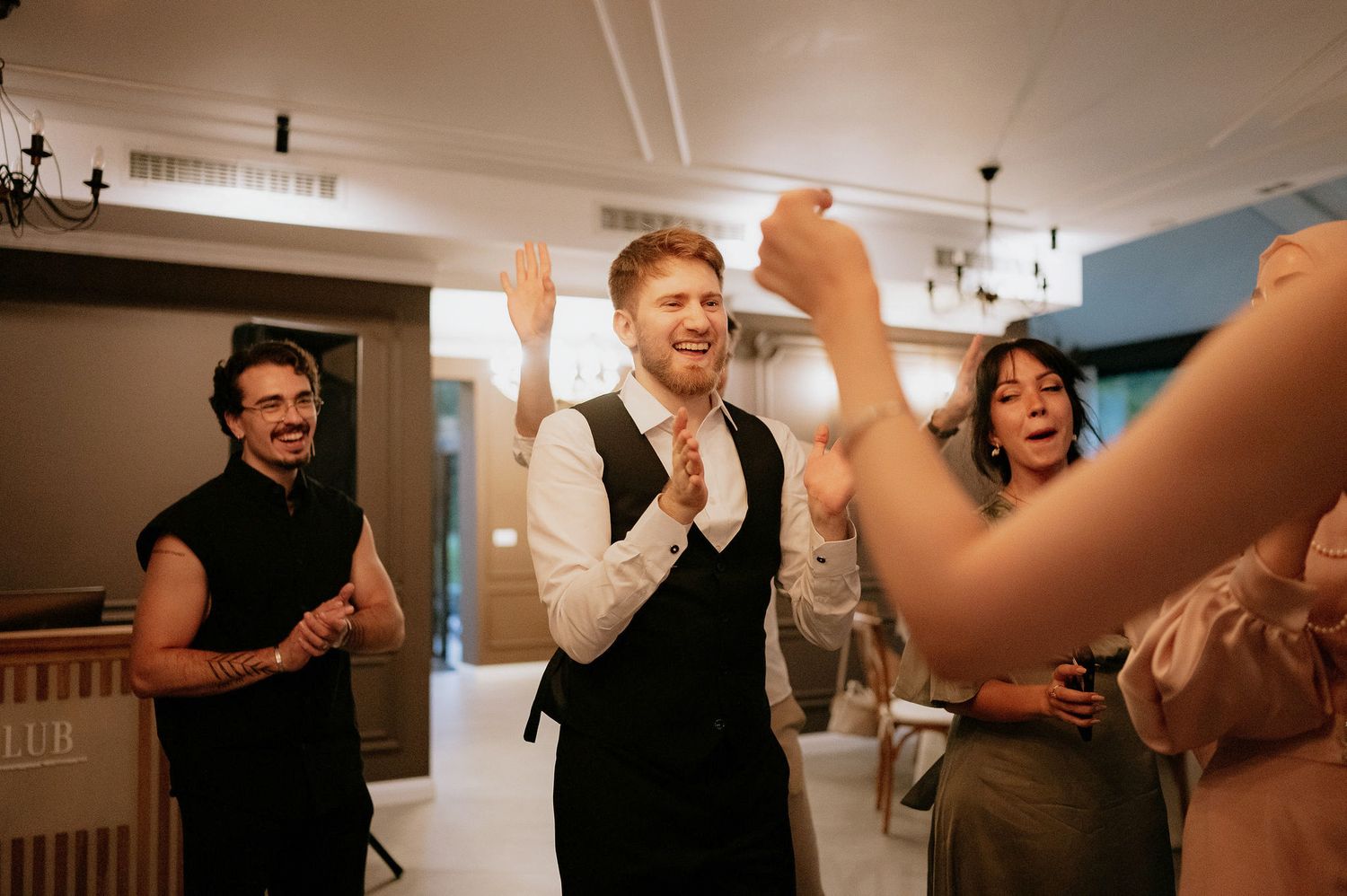 Candid moments of celebration captured in an indoor reception venue.