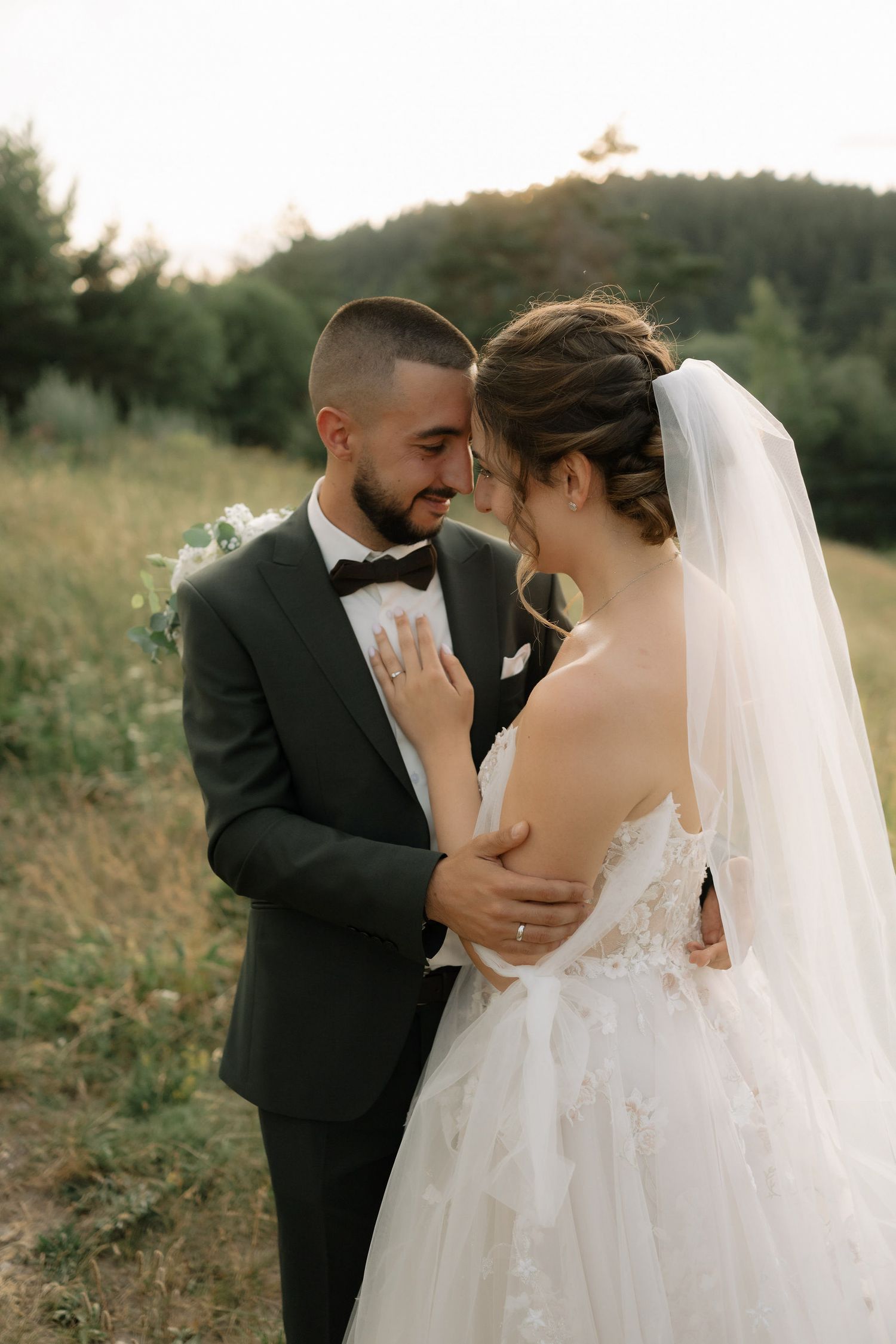 A romantic outdoor wedding photo sequence shows a couple sharing intimate moments in a natural setting at sunset.
