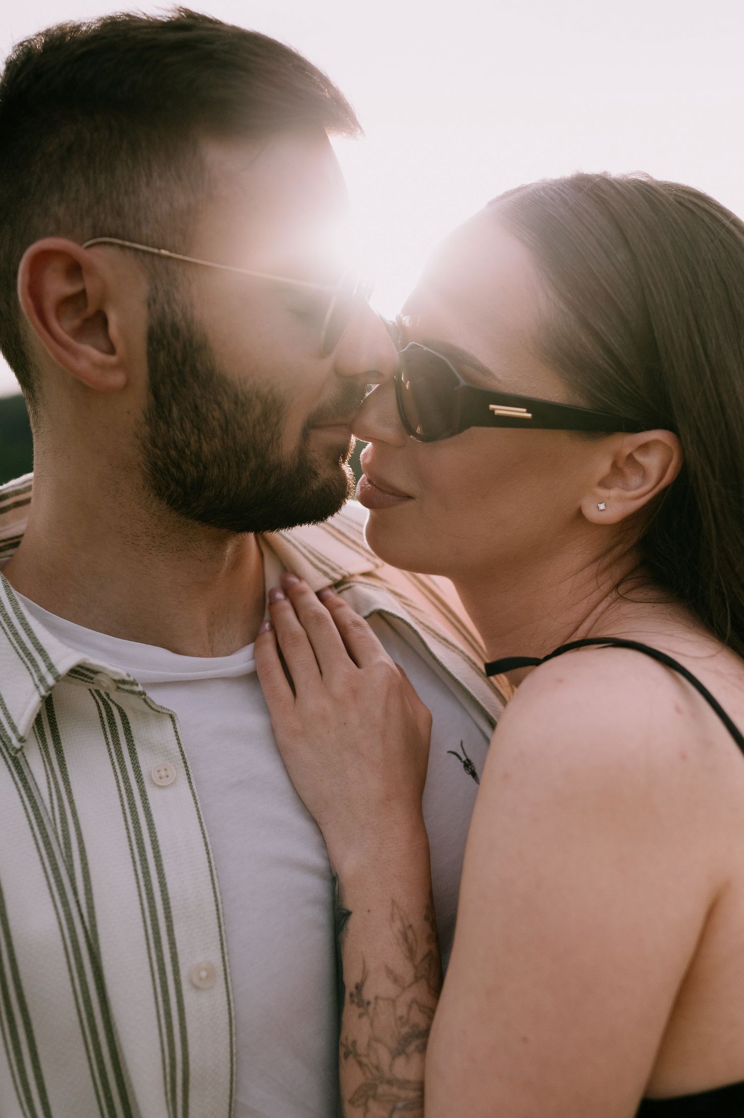 A romantic sequence of intimate moments between a couple sharing tender kisses in soft natural lighting.