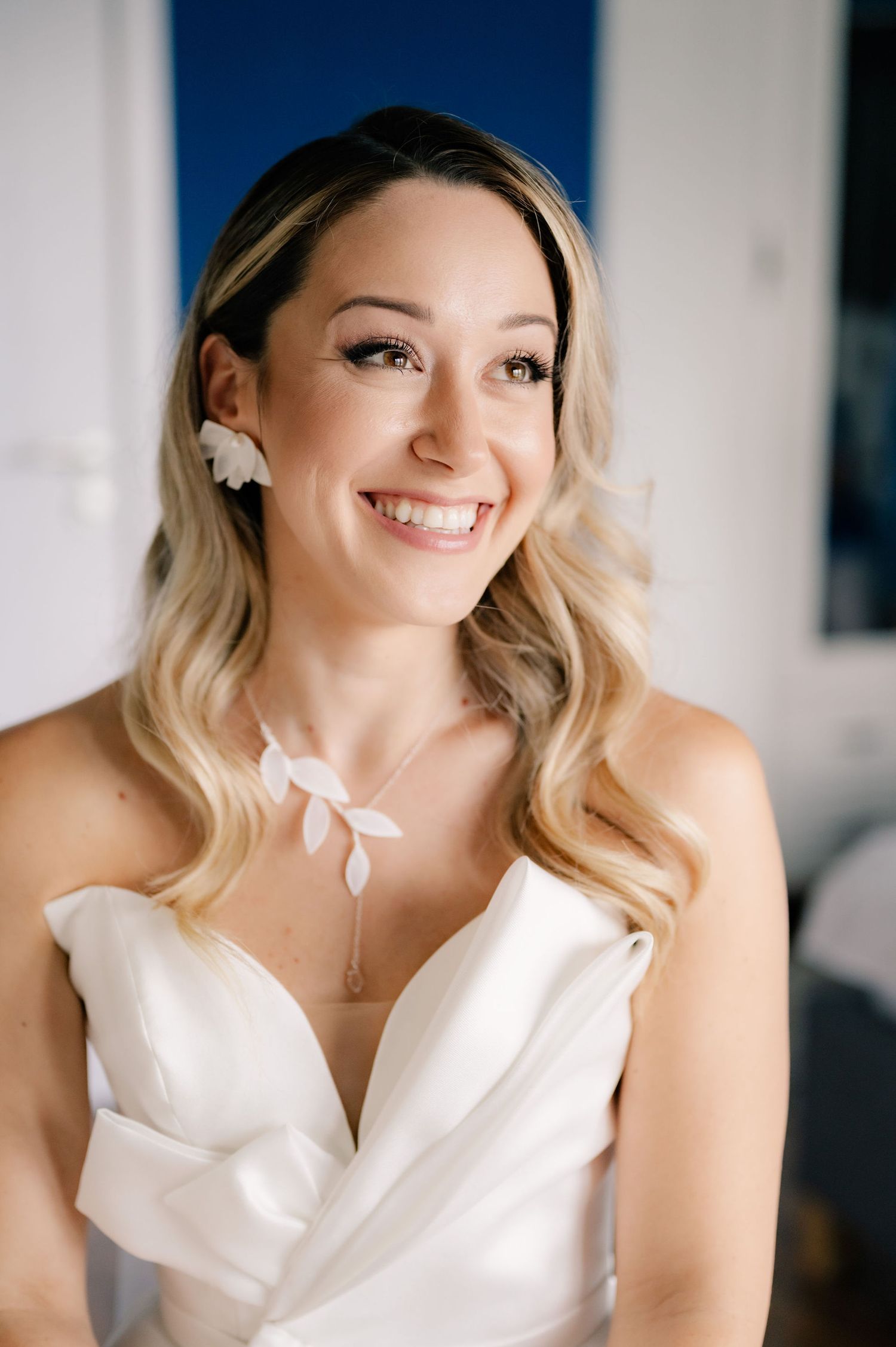A bride in a white wedding dress smiles joyfully in a series of candid portrait shots.