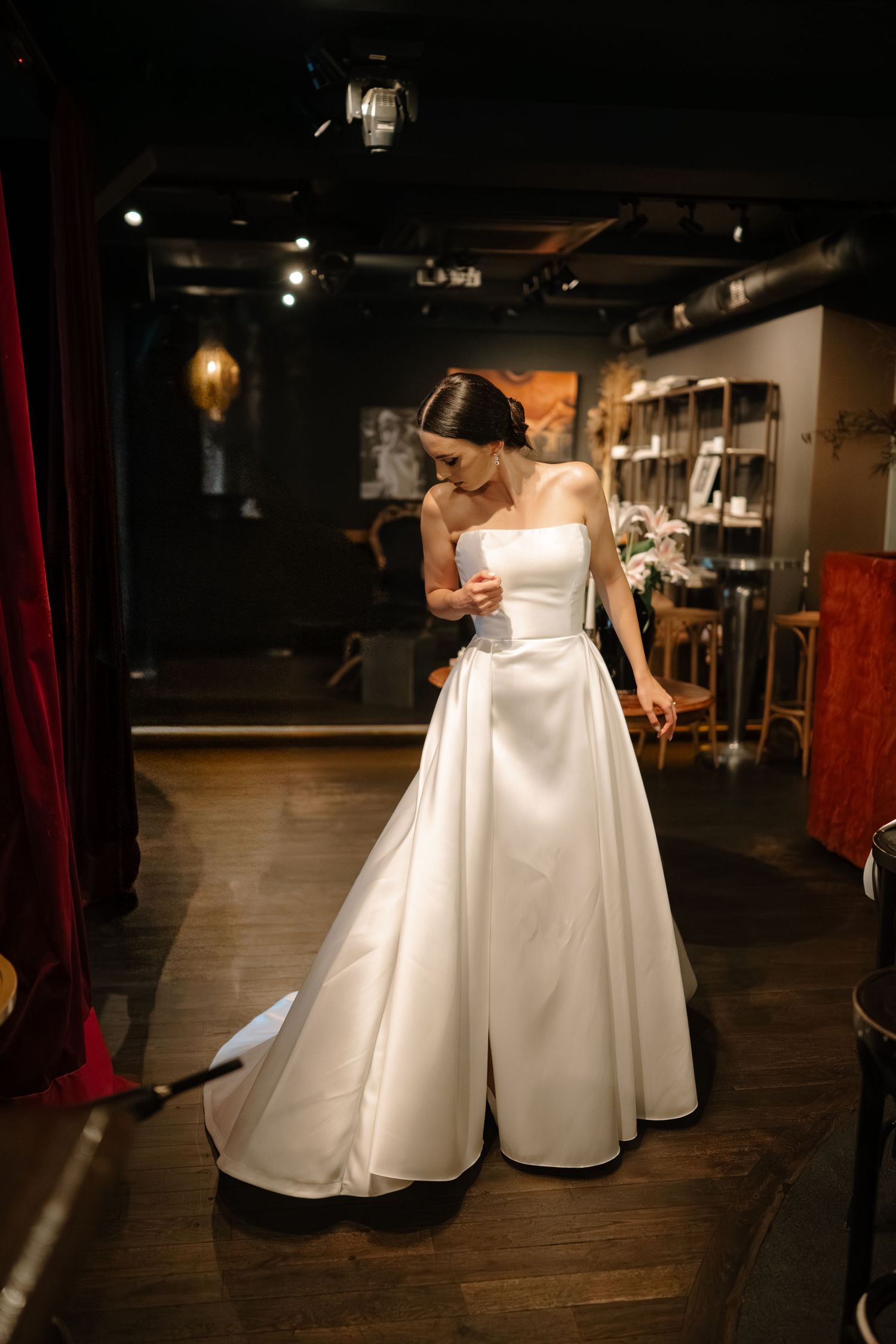 A sequence of photos showing a bride in a white wedding dress twirling and dancing in an indoor venue with dark lighting.