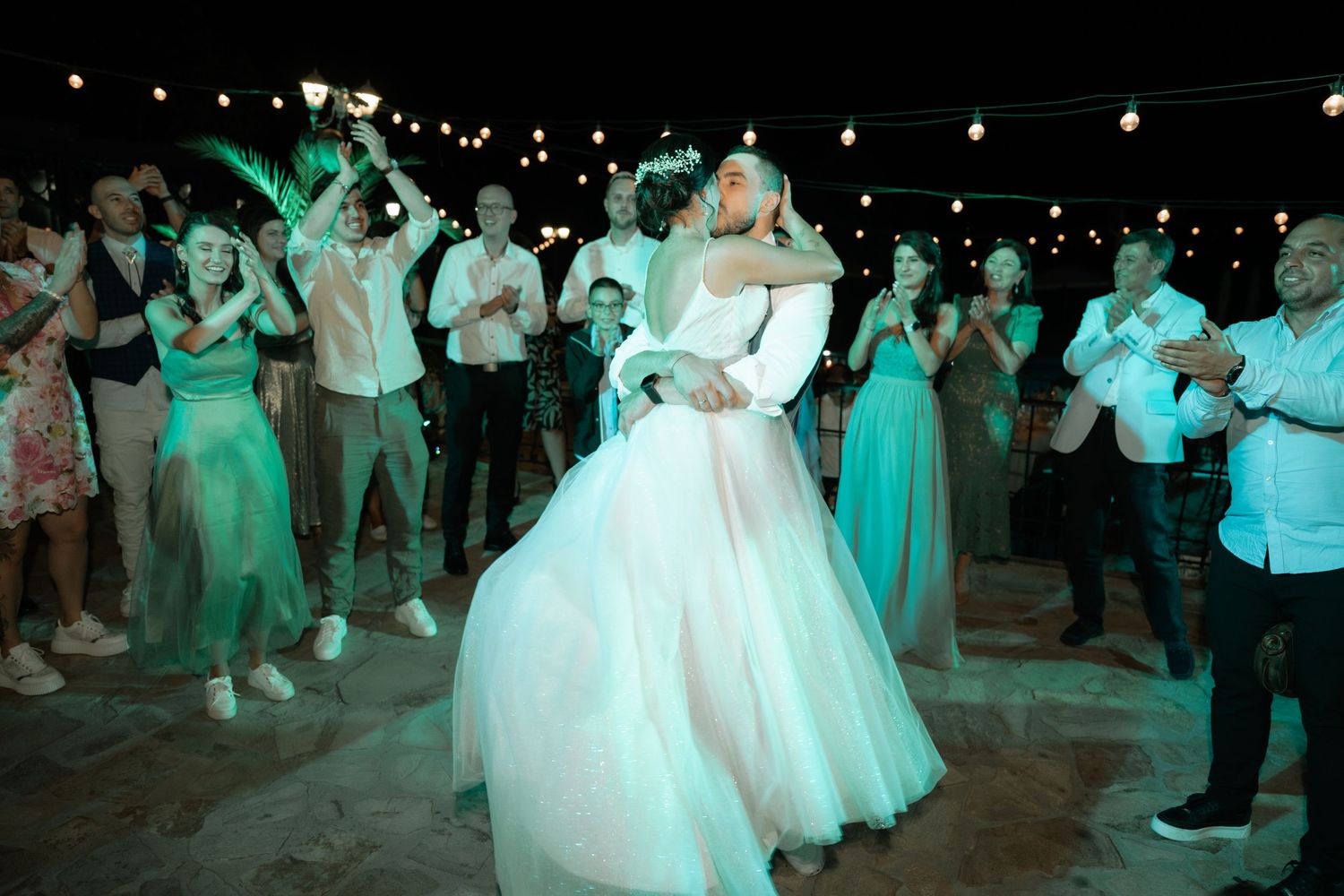 A sequence of wedding reception dance photos showing guests and a bride dancing under dim lighting with turquoise accents.