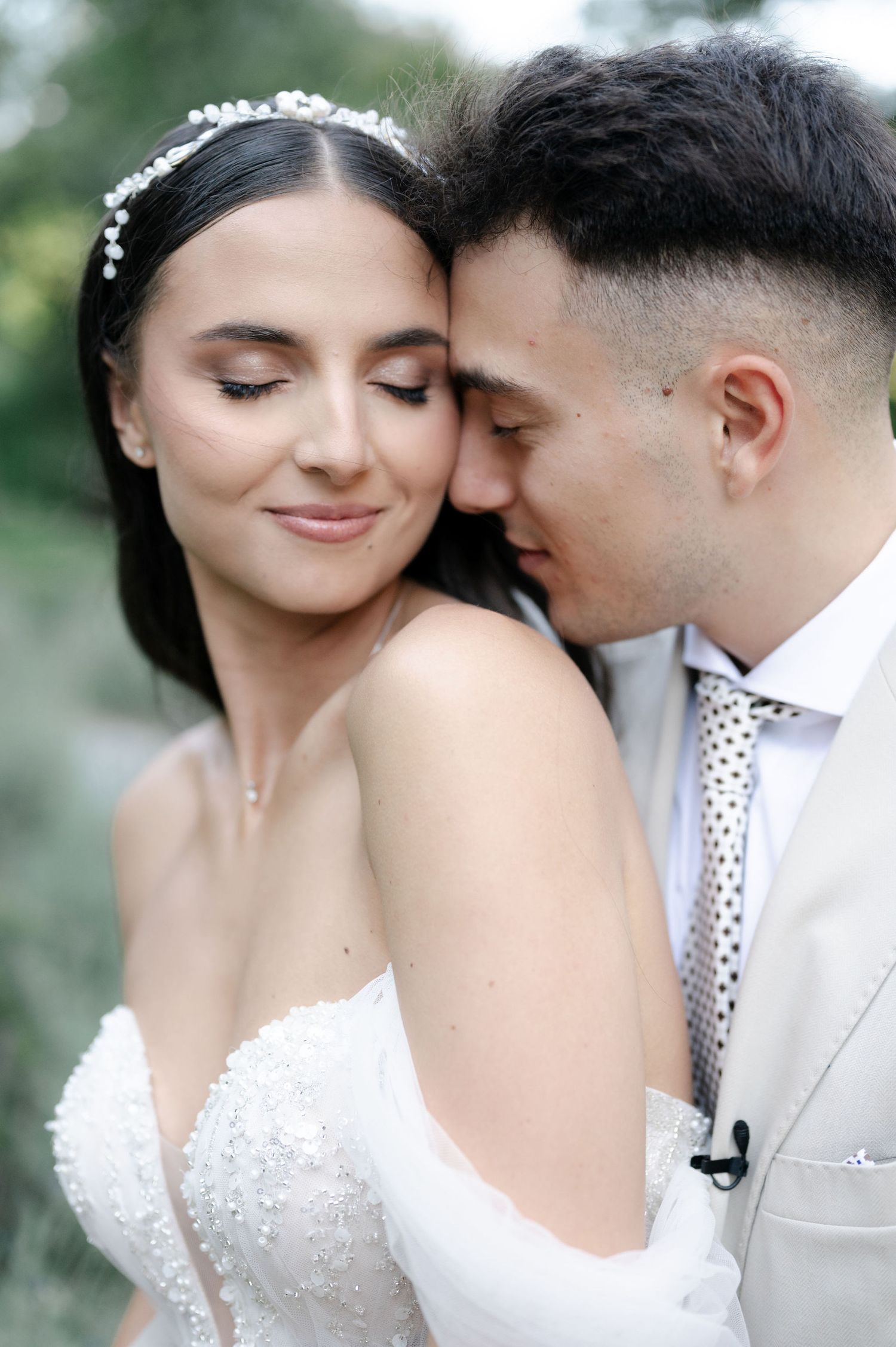 Intimate wedding portraits capturing soft moments between a couple in white formal attire.